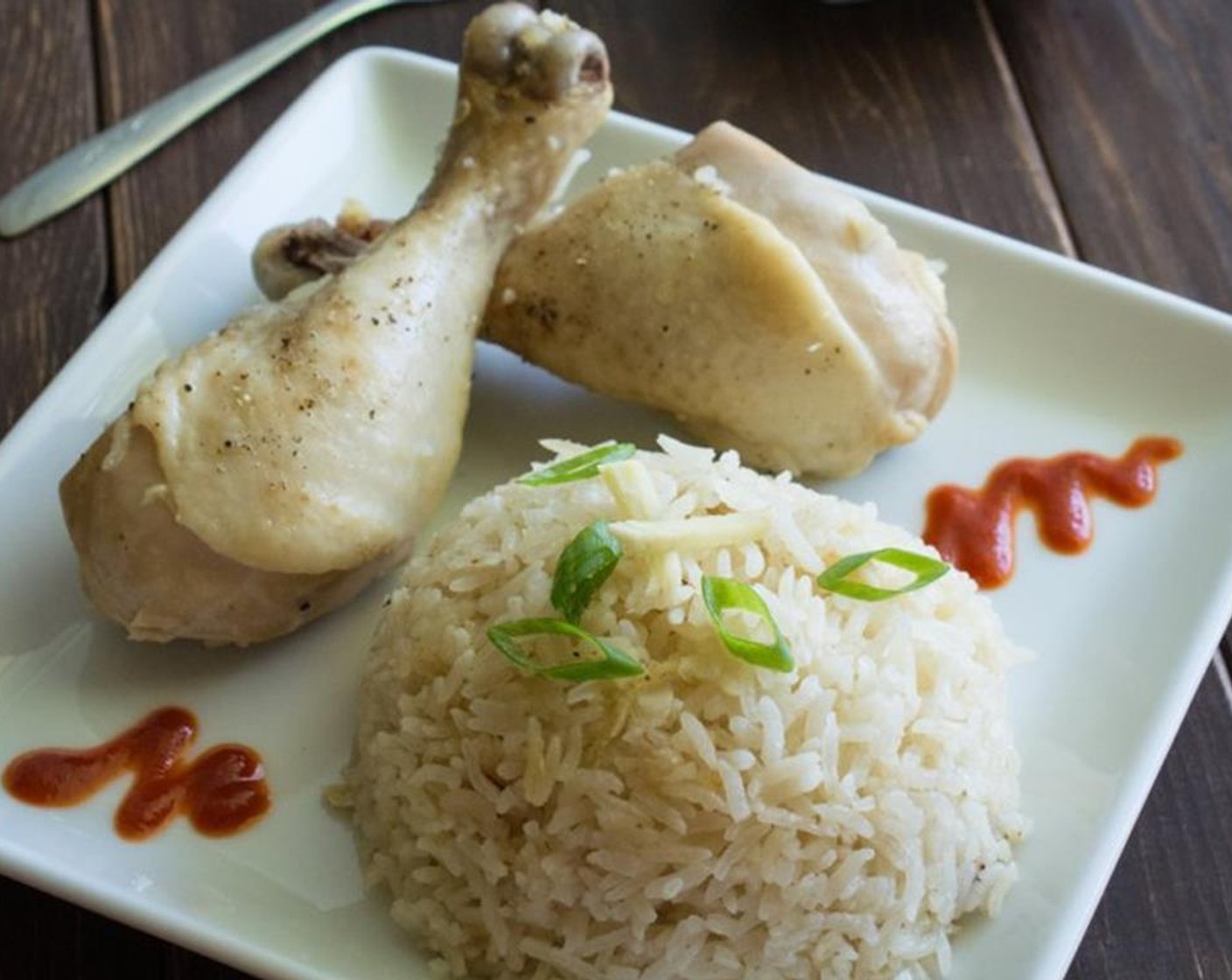 step 4 Remove the kitchen from the rice cooker and fluffy the rice with a fork or a pair of chopsticks. Serve the rice with chicken and some Hot Sauce (to taste). Garnish with Scallions (to taste).