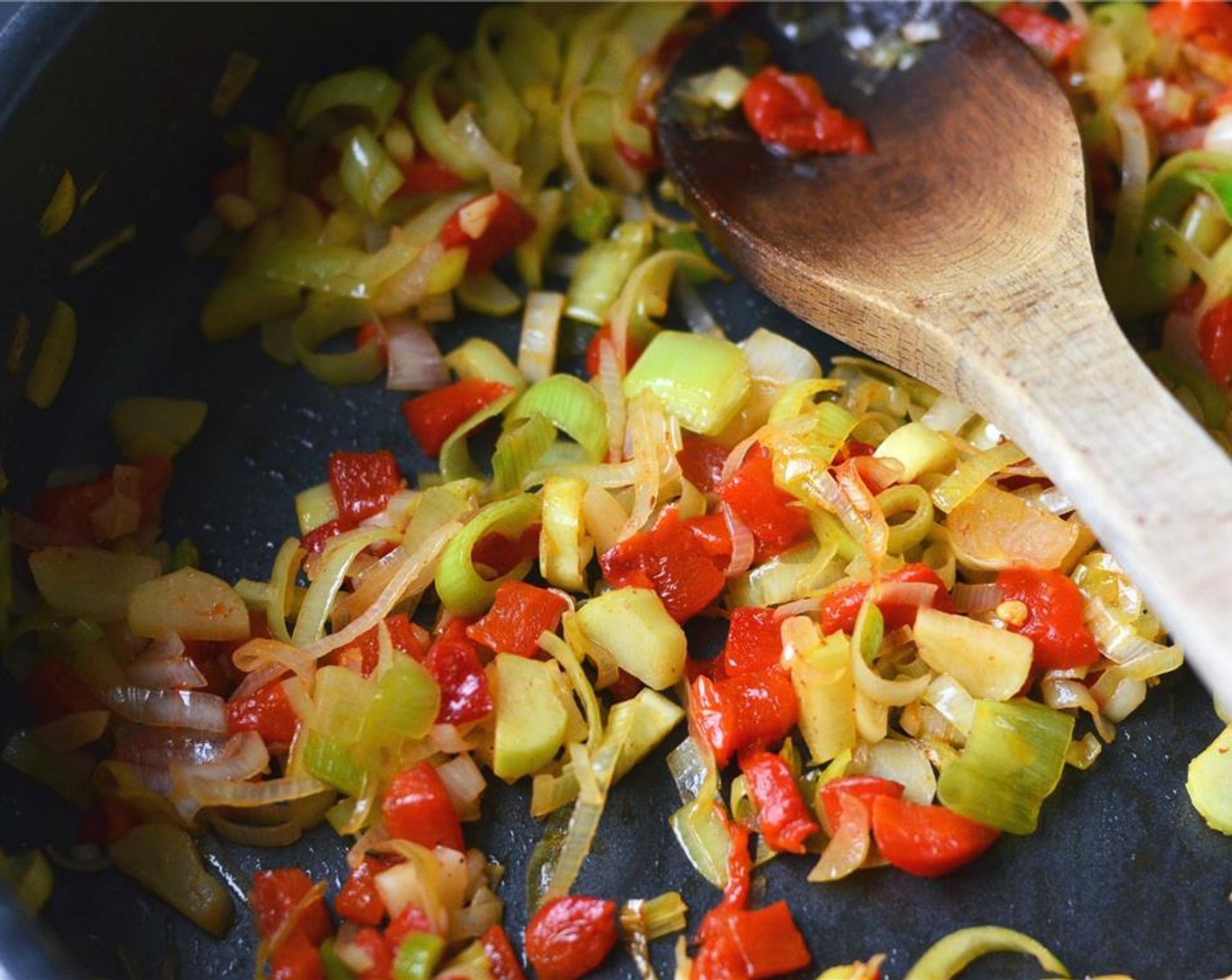 step 14 To the hot skillet with bacon grease, add Leeks (2) and Red Chili Pepper (1). Sauté over medium - high heat until leeks have softened. If they begin to brown, decrease the temperature. Remove from heat and let cool.