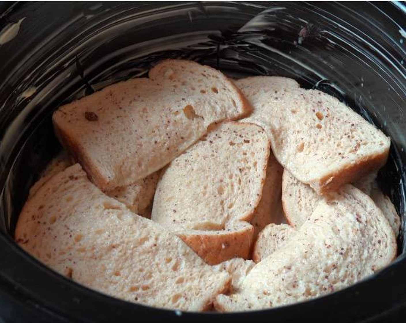 step 3 Dip each individual slice of White Sandwich Bread (1/2 pckg) into the egg mixture and then arrange it into the base of the slow cooker. Pour leftover egg mixture over the top.