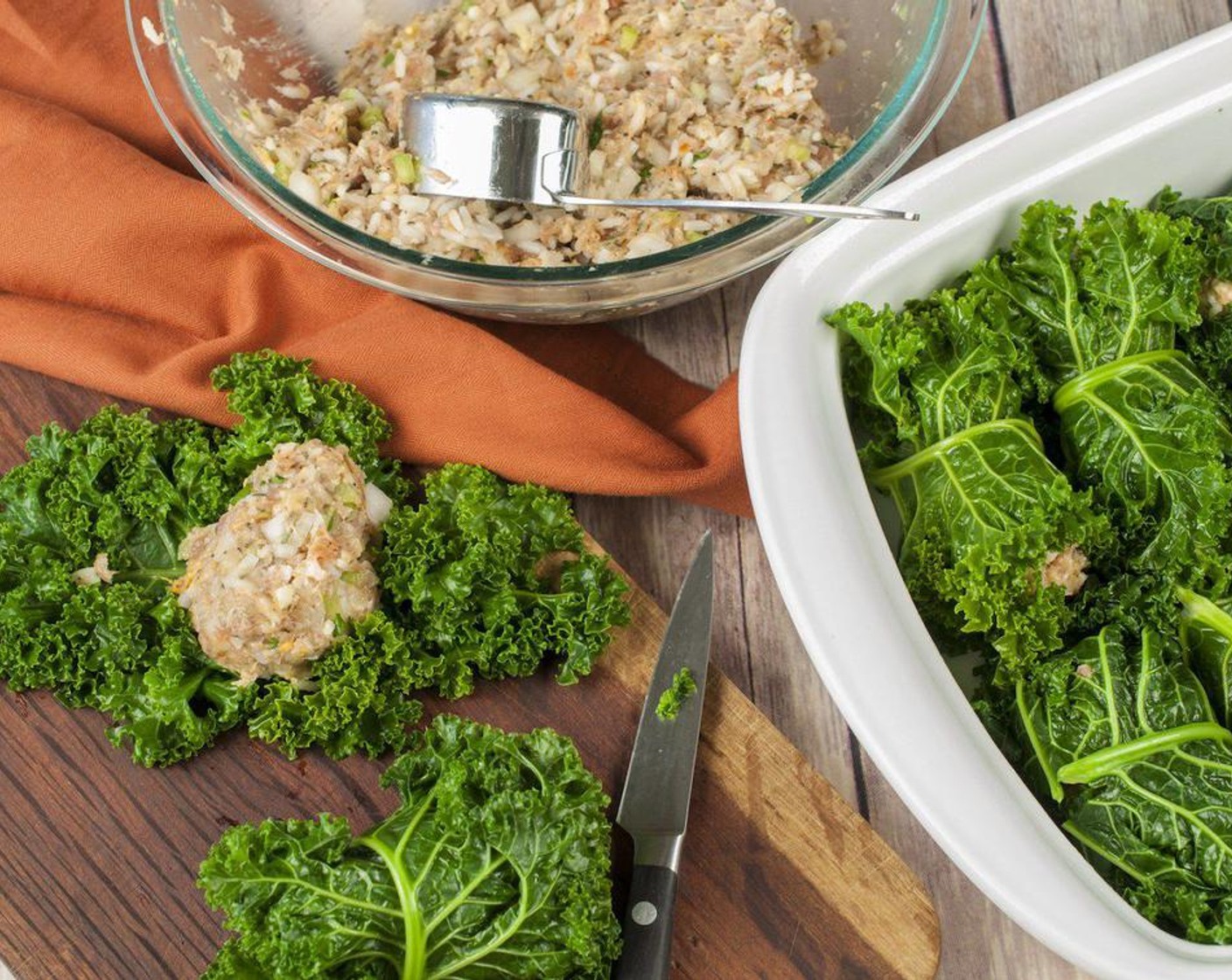 step 8 Lay a kale leaf flat and dab with a paper towel to grab any excess moisture. Scoop a generous 1/4 cup of filling onto leaf and roll leaf over filling, tucking in the sides as mush as possible. If the leaf is not large enough to tuck the sides simply press them around the filling.