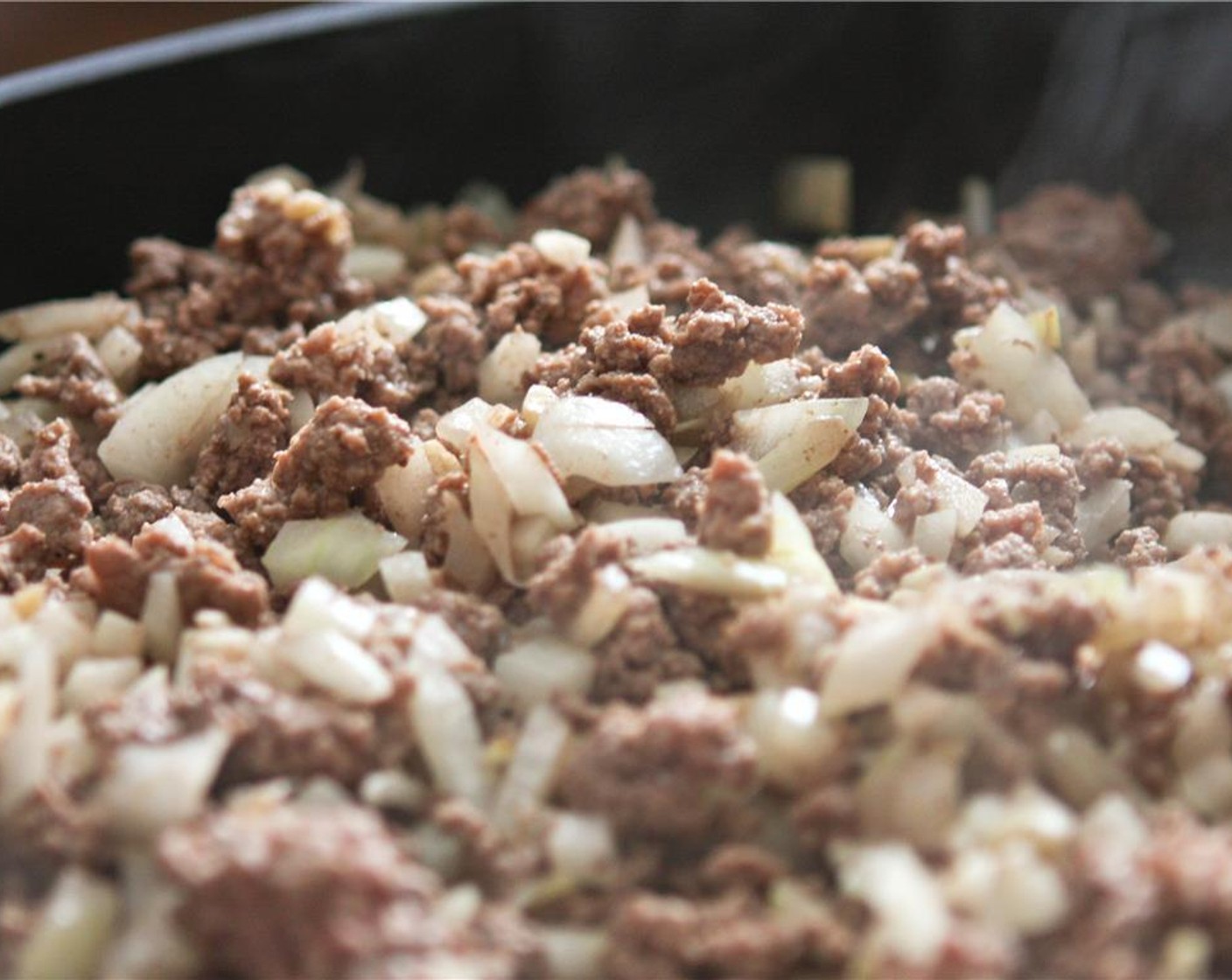step 3 In a large skillet, add the Onion (1), Lean Ground Beef (1 lb), and Garlic (3 cloves). Cook over medium heat, stirring until beef is no longer pink. Season with Salt (1/2 tsp) and Ground Black Pepper (1/2 tsp).
