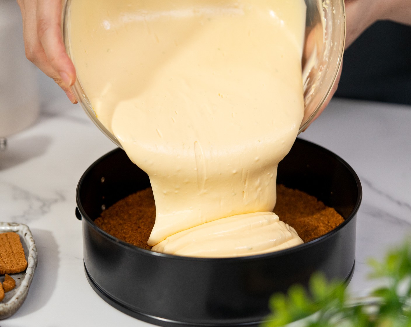 step 8 Spread the cheesecake filling on top of the base. Gently tap the cake pan a couple of times to remove the excess air bubbles. Bake for 35-40 minutes.