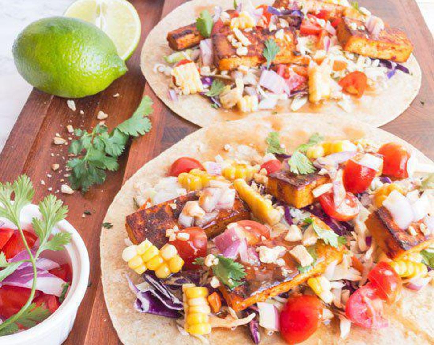 step 4 Cut corn off of the cob, fill Whole Wheat Tortilla (1 pckg) with tofu, corn, Green Cabbage (1 cup), Red Onion (1/4 cup), Fresh Cilantro (to taste), and Grape Tomatoes (to taste) and top with peanut dressing.