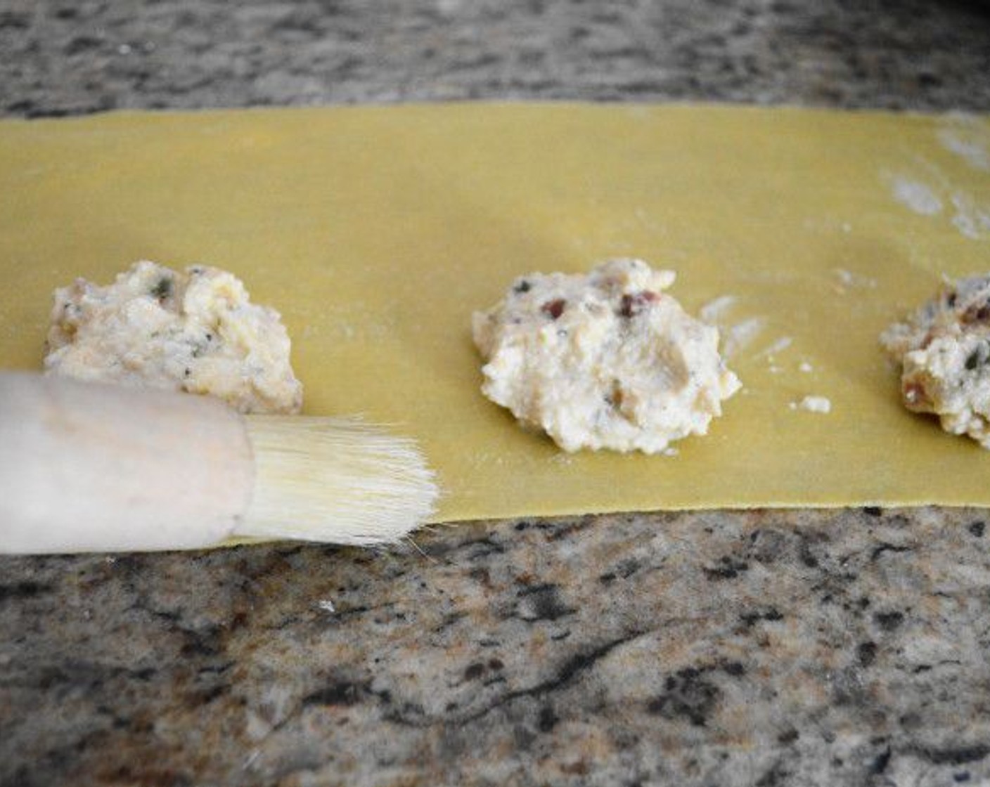 step 18 Brush the edge of dough closest to you with water, then bring the other half over to seal in the filling.