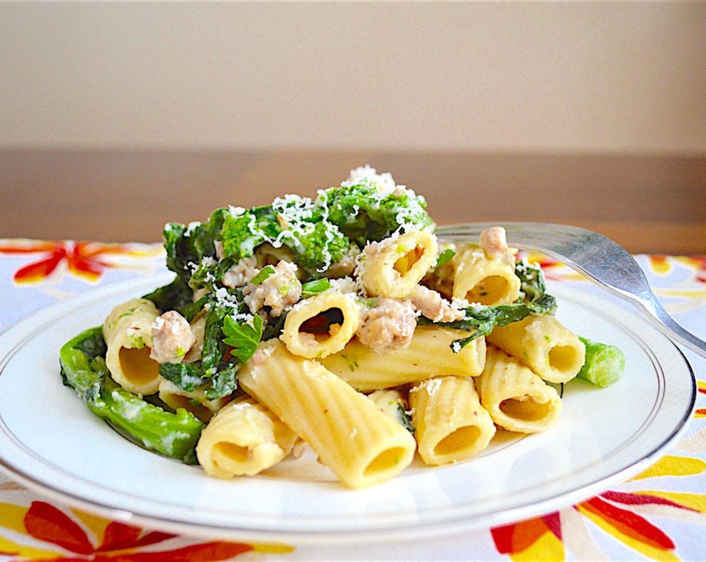 step 10 Drain it and transfer it to a huge pasta serving bowl. Pour the sauce right over it and thoroughly toss it all together. Serve family style immediately with extra grated asiago cheese on top! Enjoy!