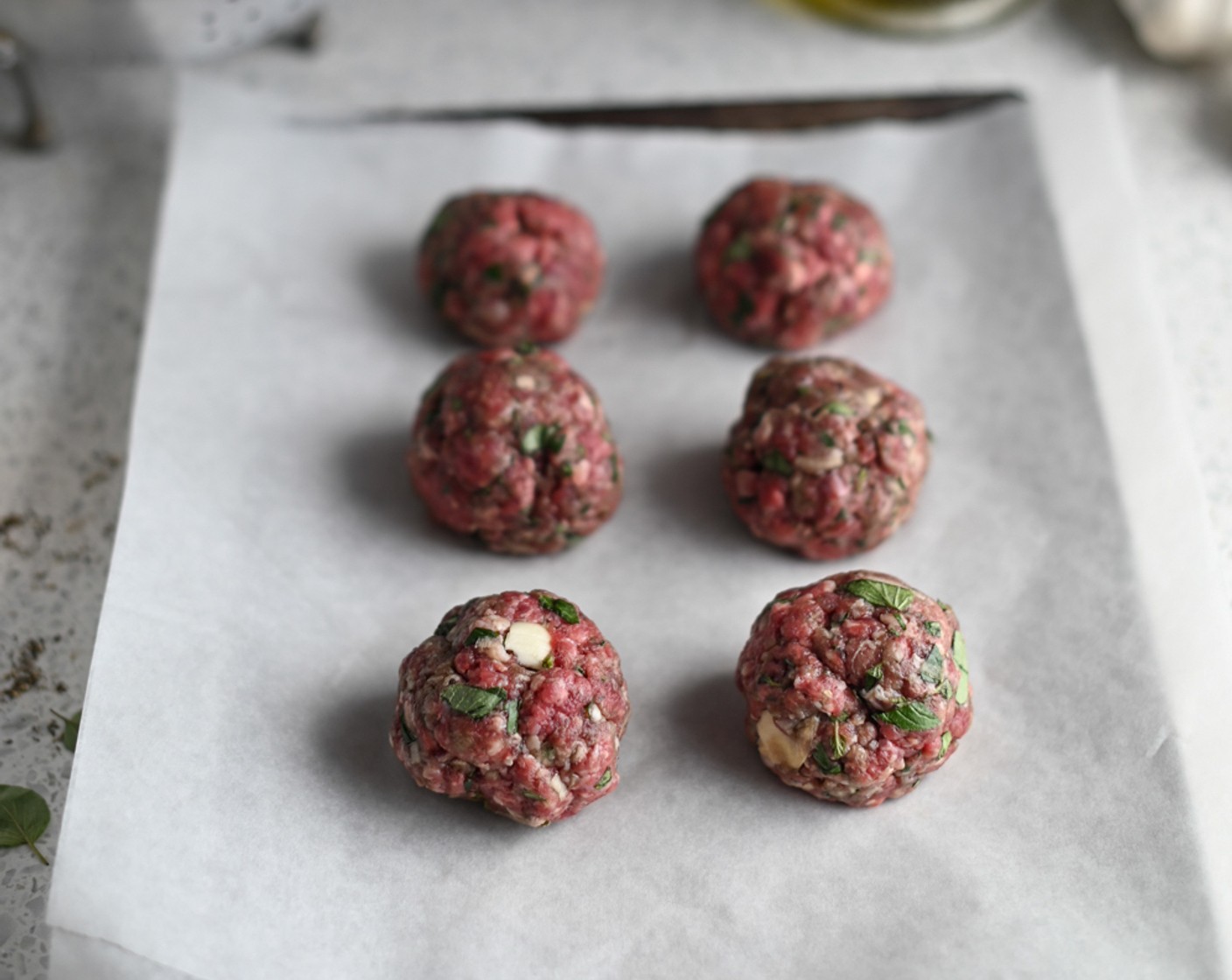 step 4 Form the mixture into 6-12 large meatballs and arrange them on a lined baking sheet.