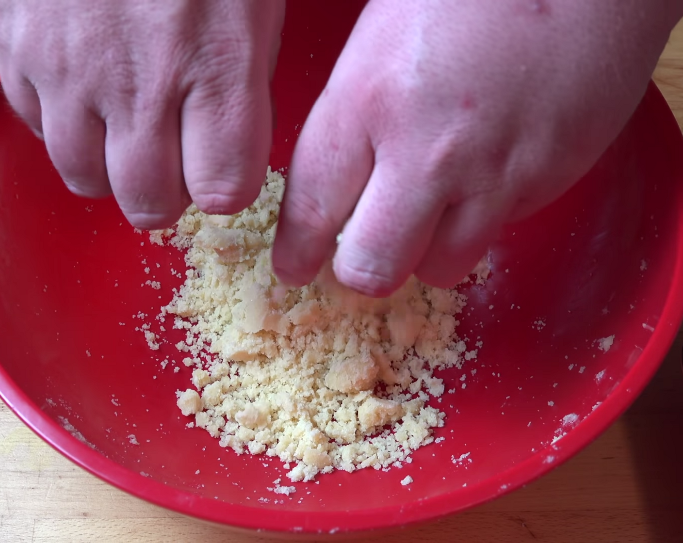 step 9 Meanwhile, prepare the crumble mixture. Using clean hands (fingers and thumbs), rub the remaining dough together until nubbly bits of dough start coming together.