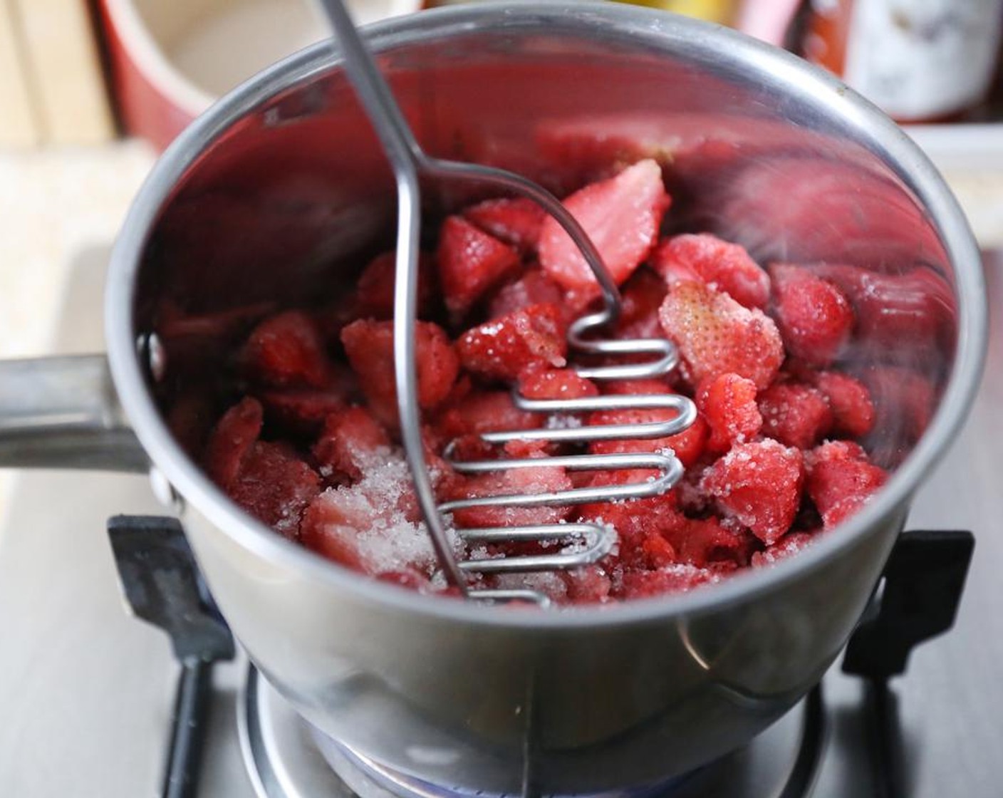 step 2 Using a potato masher or large fork, roughly mash the fruit.