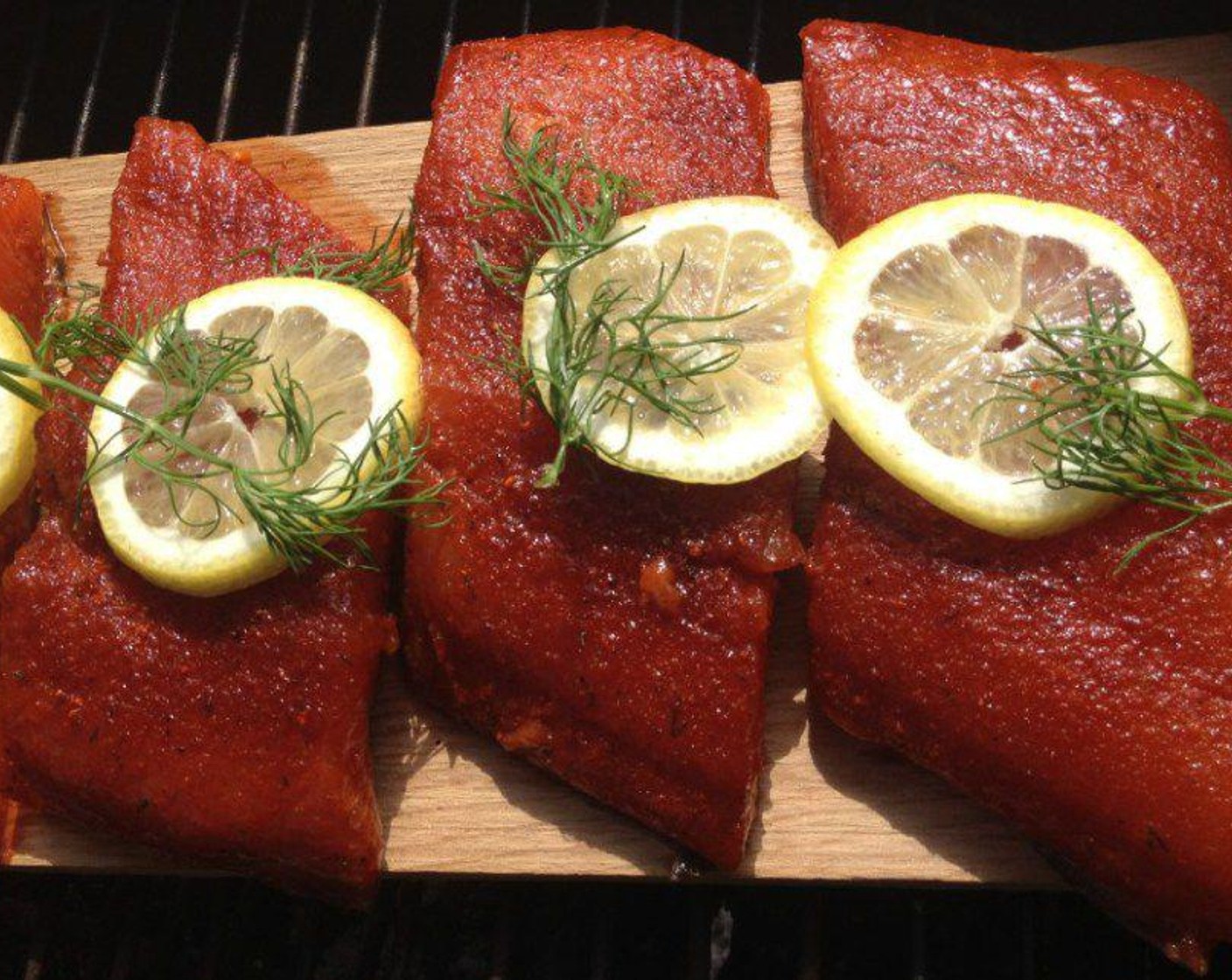 step 7 Once it’s warm, arrange the salmon filets on the board and top with a Lemons (6 slices) and sprigs of dill. Cover the grill and let it cook for 10 minutes; at this point, baste with the remaining butter mixture. It takes about 20-30 minutes of total grill time for the salmon to fully cook.