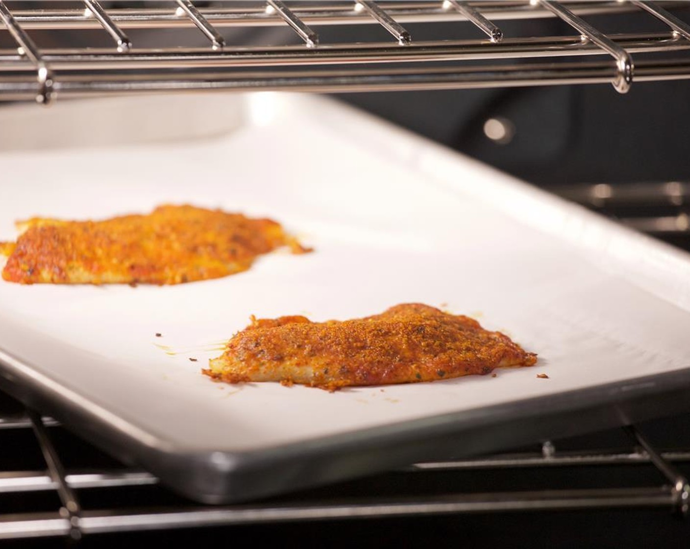 step 8 Place the fillets on a sheet pan lined with parchment paper and bake in the oven for 11 minutes until the fish flakes easily with a fork.