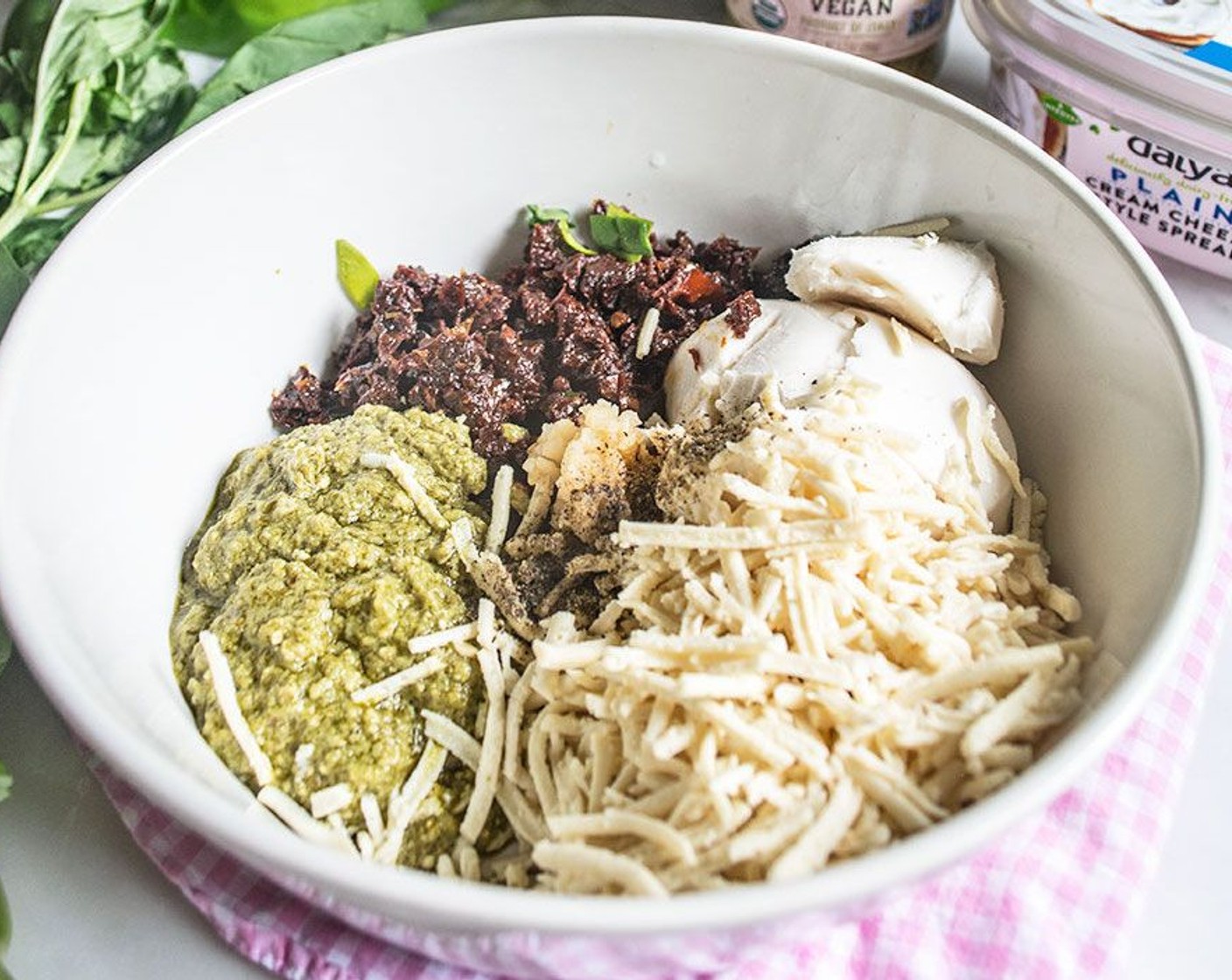 step 1 To a medium bowl, add Vegan Cream Cheese (8 oz), Vegan Mozzarella Cheese (1 cup), Sun-Dried Tomatoes in Olive Oil (2/3 cup), Vegan Basil Pesto (1/2 cup), Pecans (1/2 cup), Garlic (1 tsp), and Ground Black Pepper (1/2 tsp). Stir until well combined.