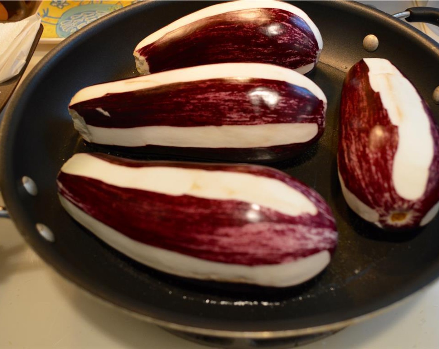 step 4 Add Vegetable Oil (1/2 cup) into a saute pan so it covers the bottom. Place eggplants into the hot oil to allow them to fry. Flip each eggplant to ensure even cooking.