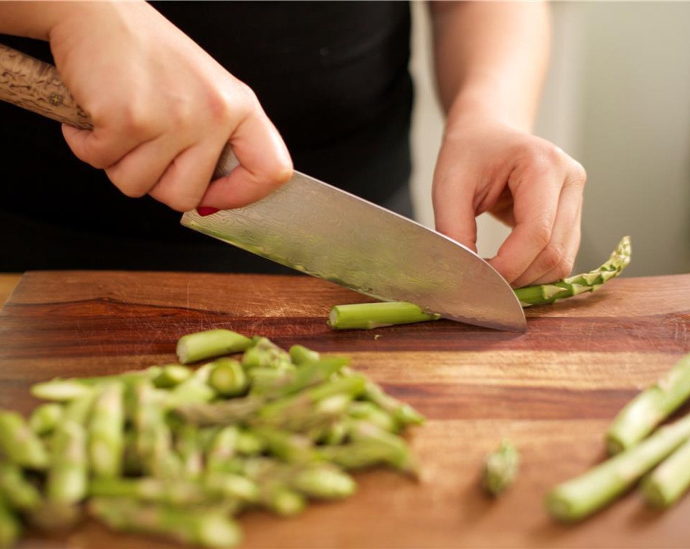 step 2 Trim Asparagus (1 2/3 cups) by snapping the thicker bottom ends where they break naturally. Cut into one inch pieces on the bias, and set aside.