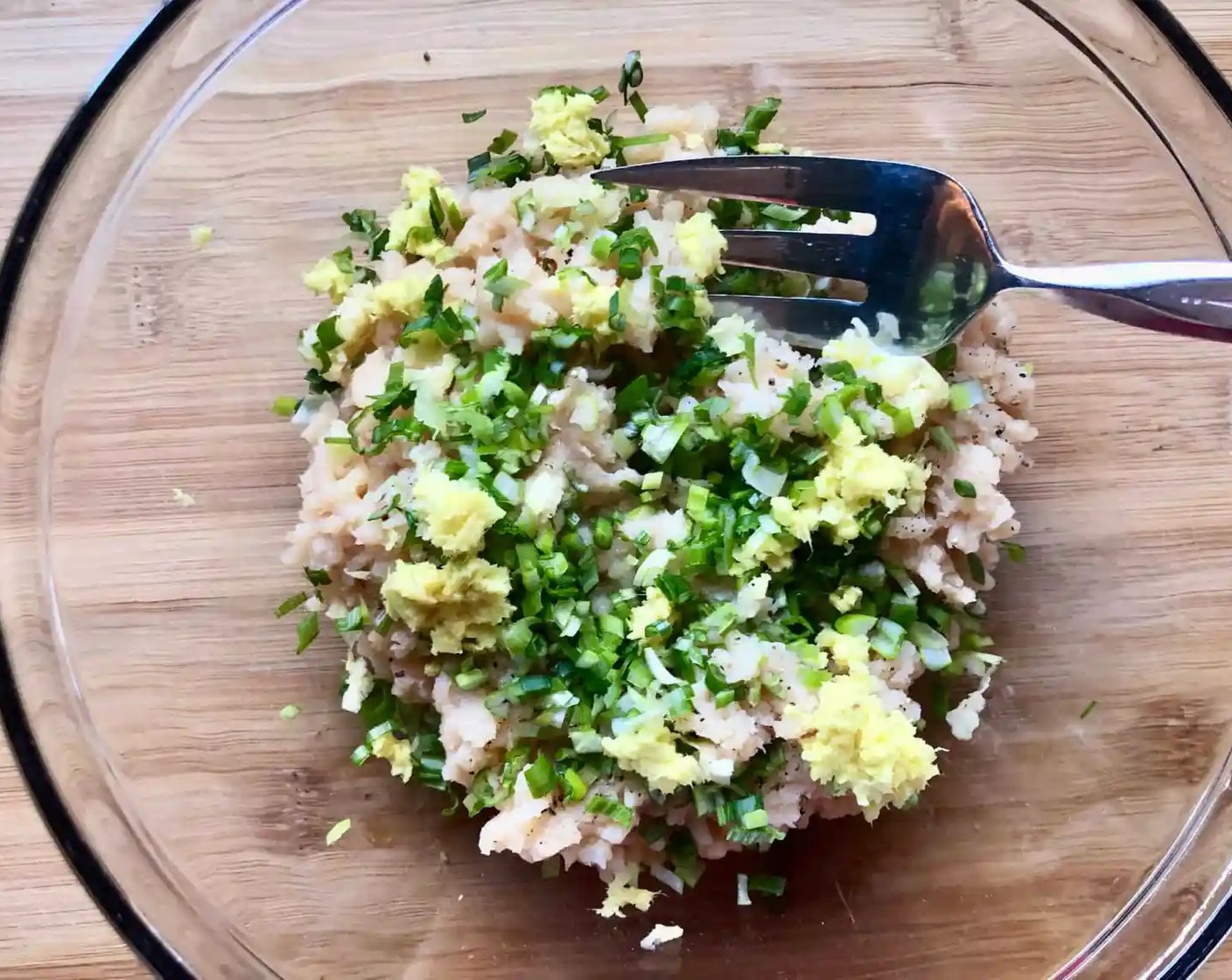 step 1 Add the Ground Chicken (1 lb), Scallion (1 bunch), Fresh Ginger (1 piece), Garlic (1 clove), and a pinch of Freshly Ground Black Pepper (to taste) to a medium-size bowl. Gently mix until just combined.