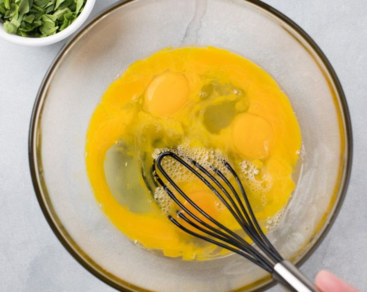 step 5 In a large bowl, whisk the Eggs (5). Add the Mild Banana Pepper (1/4 cup), Fresh Spinach (1/2 cup), and Salt (1/4 tsp) and whisk again until all is incorporated.