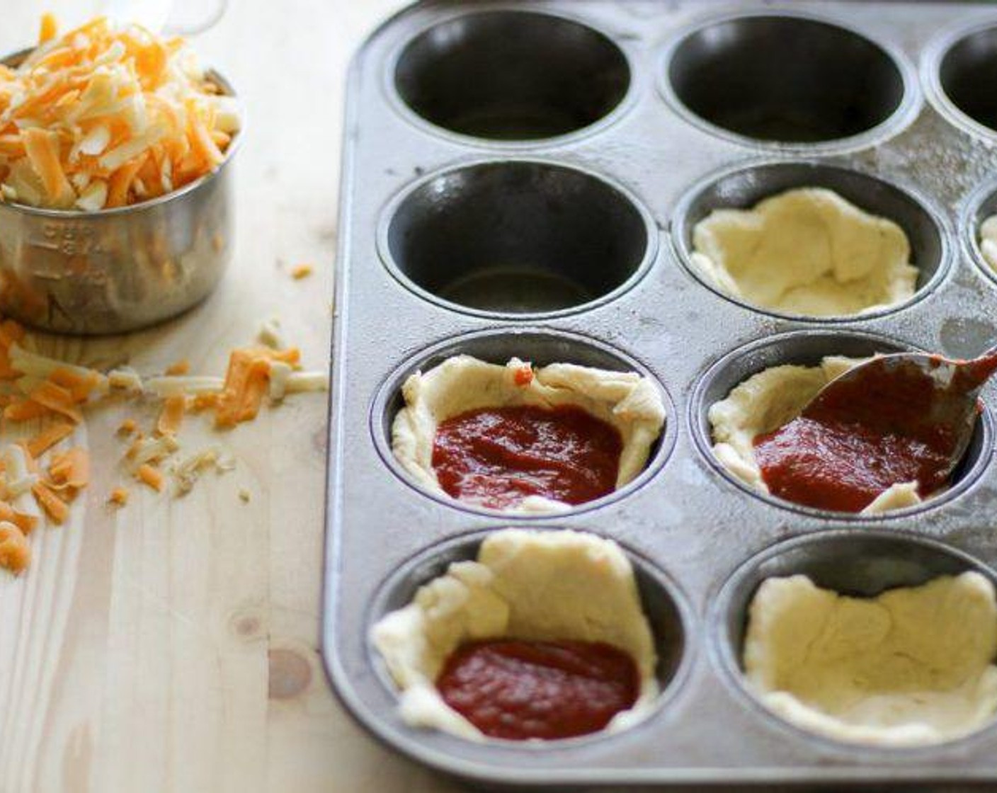 step 2 Unroll the Crescent Roll Dough (1 pckg) triangles. Form the cresent dough triangles into a circular disc. Gently press the crescent dough into the bottom of each muffin tin.