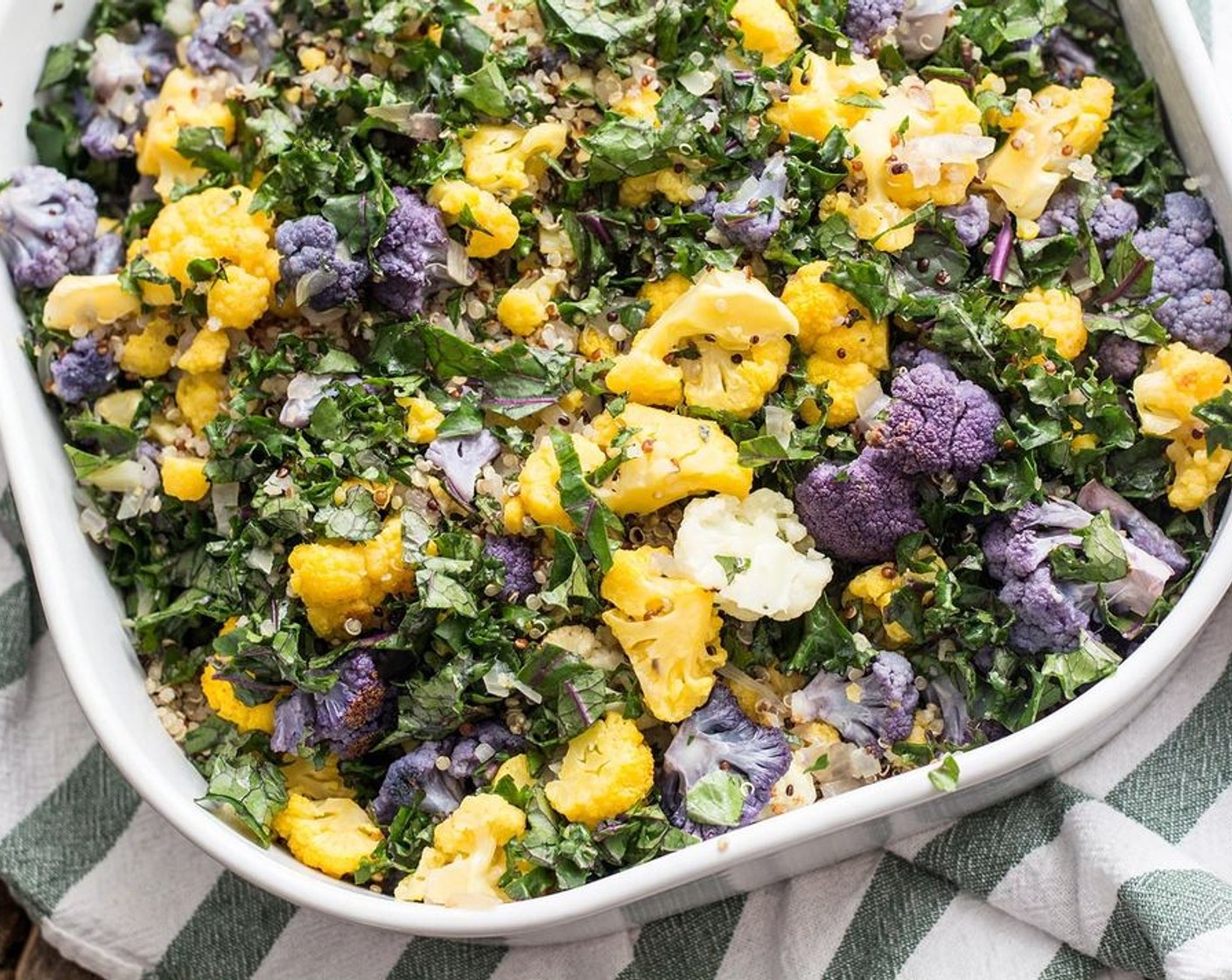 step 6 Add the Quinoa (2 cups) and roasted veggies to an oven-safe casserole dish, spreading evenly. Add in the Kale (4 cups) and toss to combine.