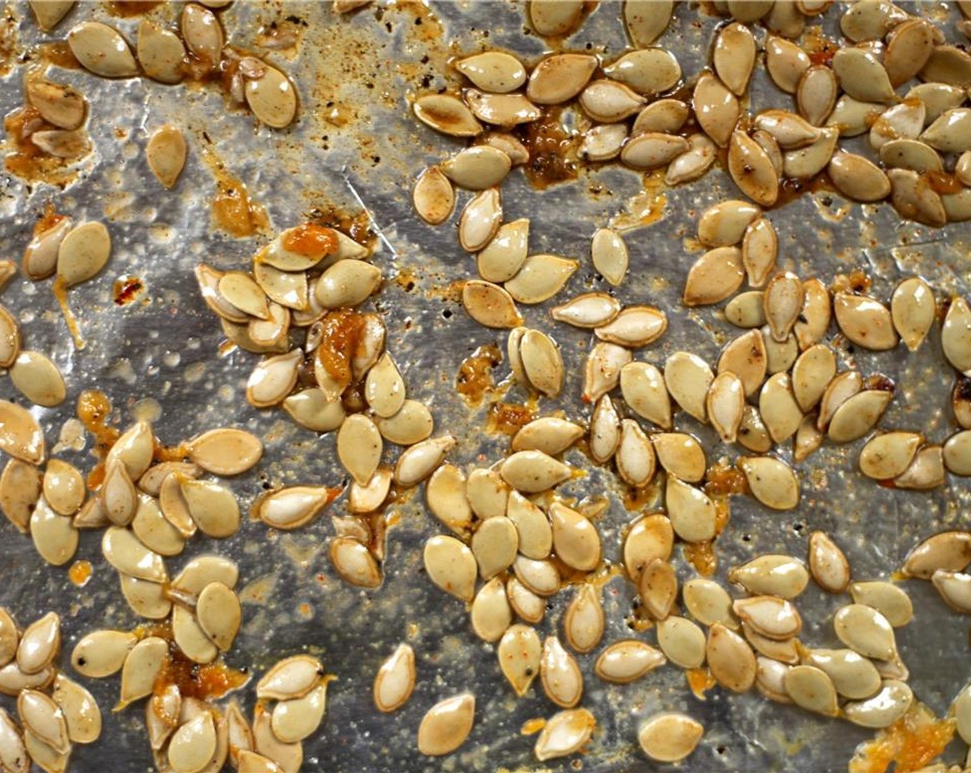 step 9 Use the same pan as the squash. Toss the seeds in the Olive Oil (1/4 tsp), Salt (1/4 tsp), Paprika (1/4 tsp), Ground Cumin (1/4 tsp), and Ground Black Pepper (1 pinch) evenly on the pan. Toast in the oven for 10 minutes, tossing halfway through.