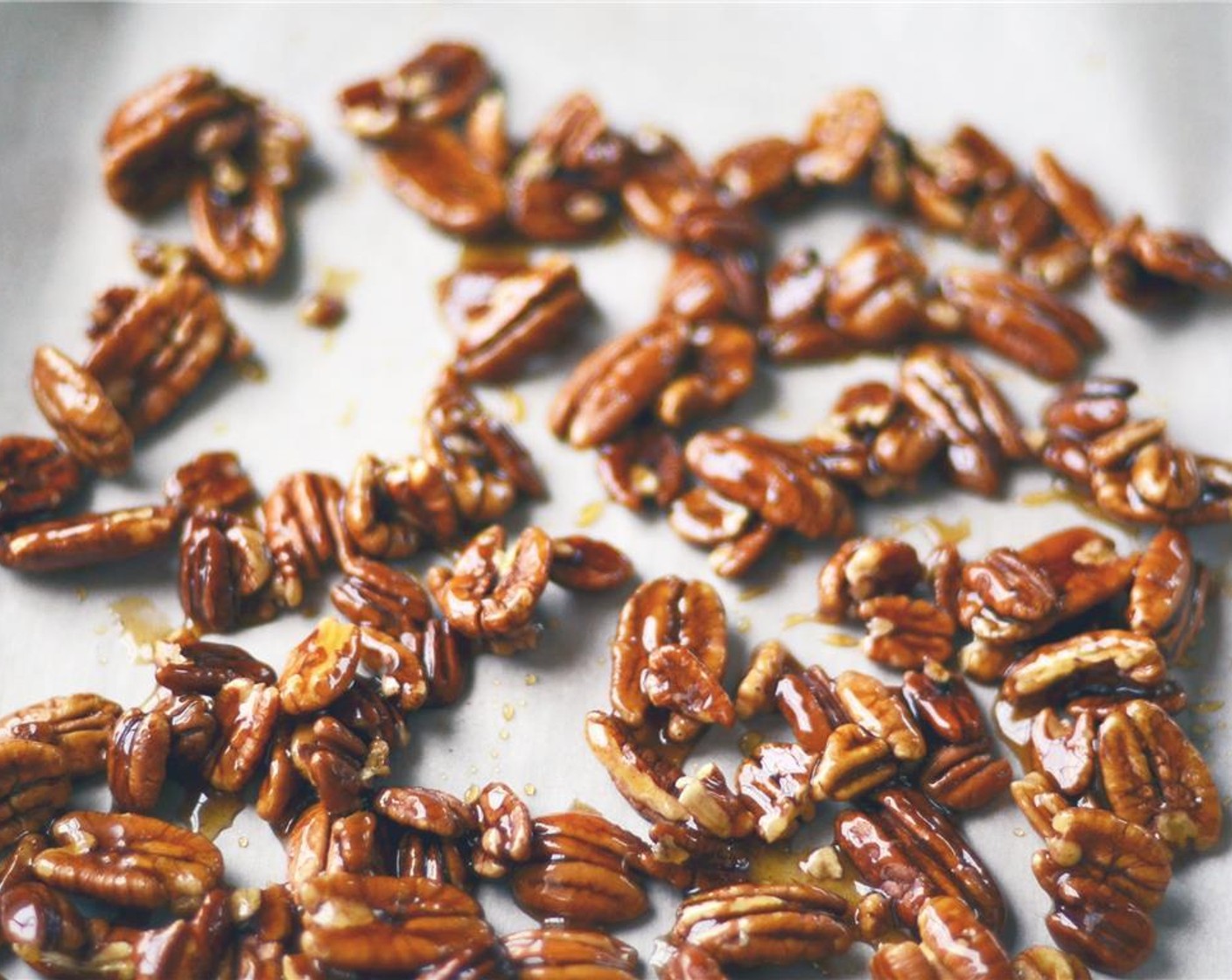 step 4 Pour pecans out onto prepared baking sheet, separating pecans with a fork until they are in a single layer. Place in preheated oven and bake for 6 minutes.