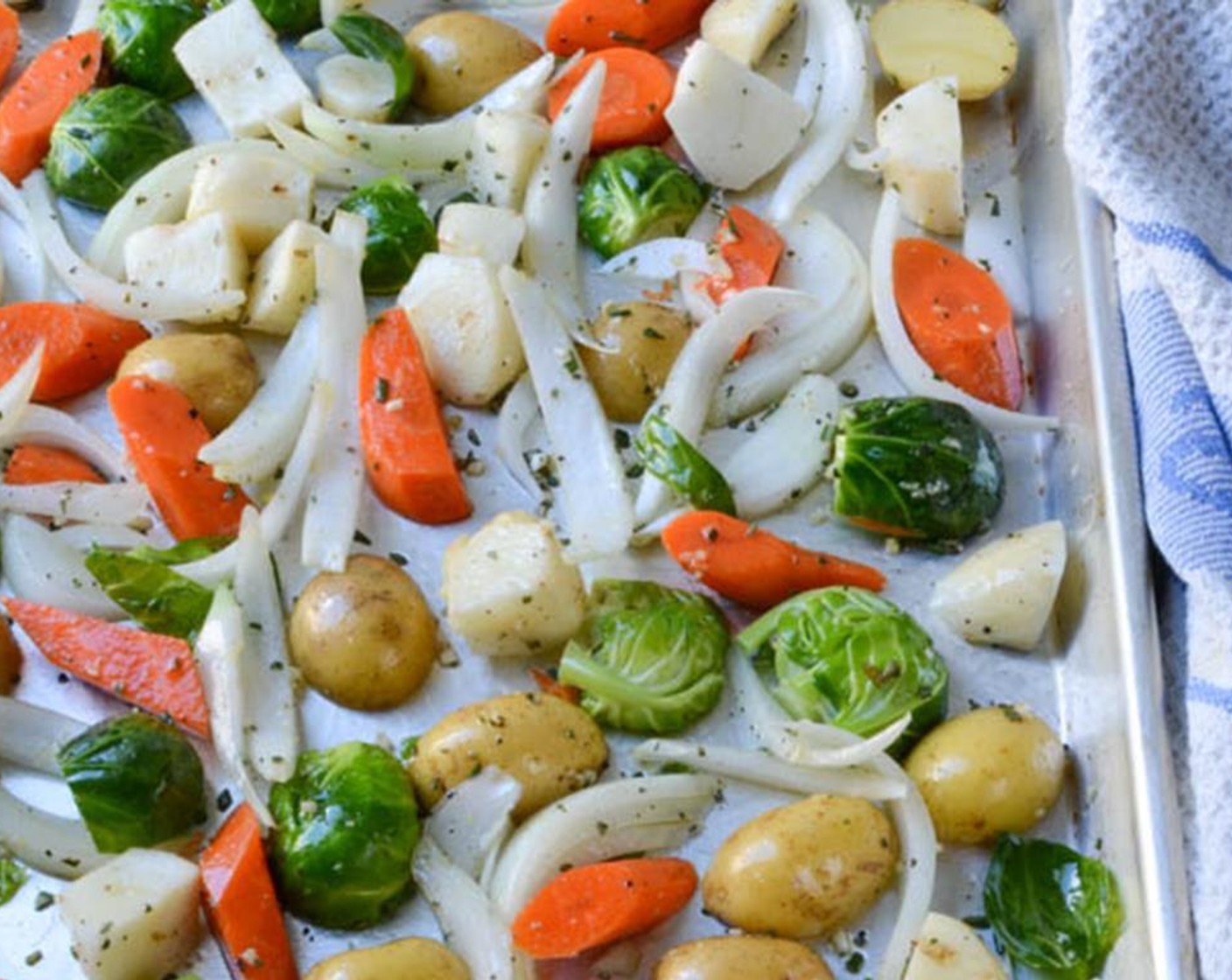 step 6 When they are coated, arrange the vegetables so that the cut side of the brussels sprouts and potatoes are on the cookie sheet. Spread the rest of the vegetables out in an even layer.