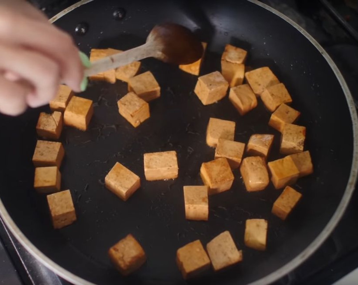 step 2 Heat a skillet over medium-high heat and add a generous splash of oil. Add cubed tofu and cook stirring occasionally, until all sides are golden brown. Remove tofu from skillet and set aside.