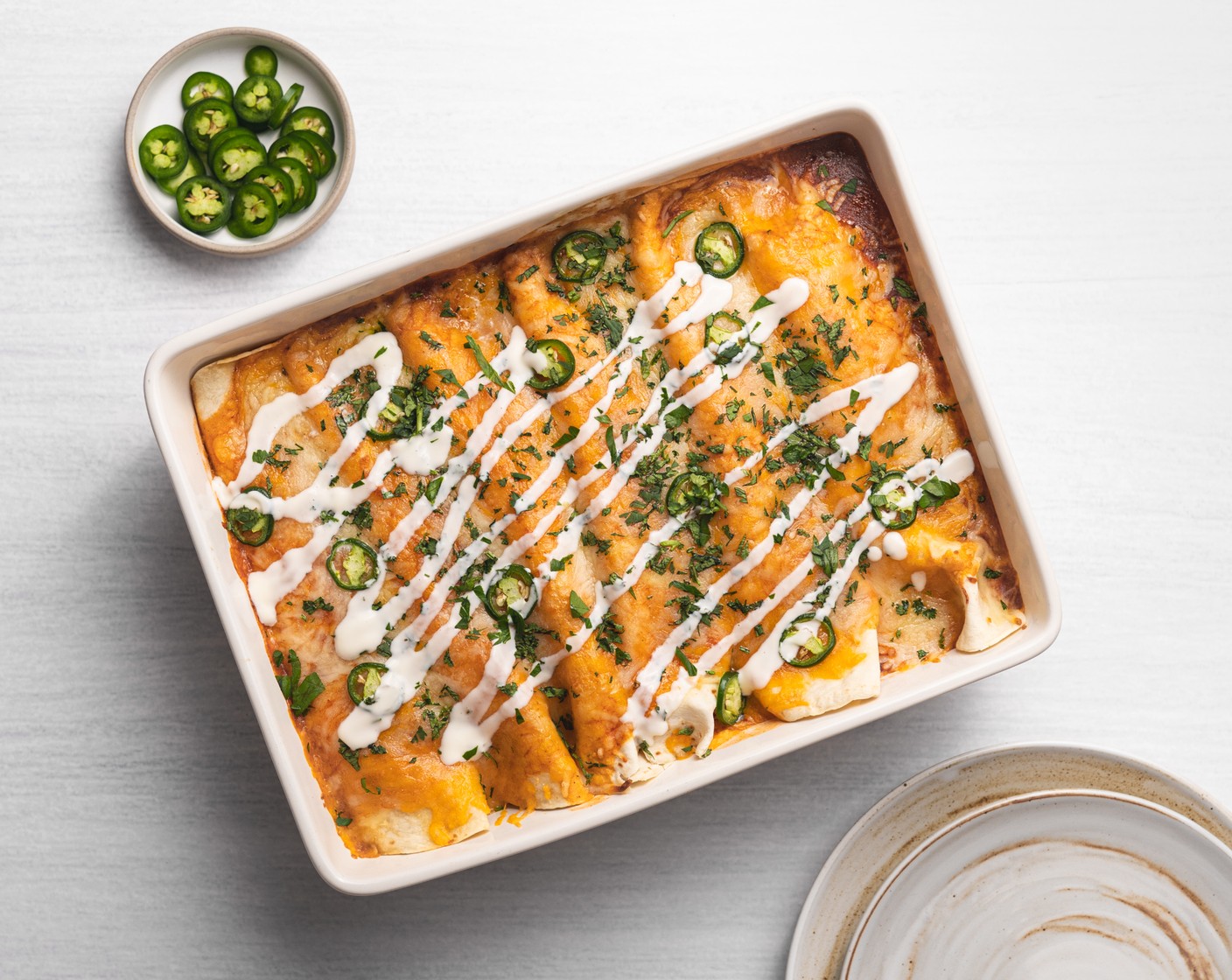 step 8 Let the enchiladas set for 5-10 minutes at room temperature. Serve with Fresh Cilantro (to taste) and Sour Cream (to taste) on top.