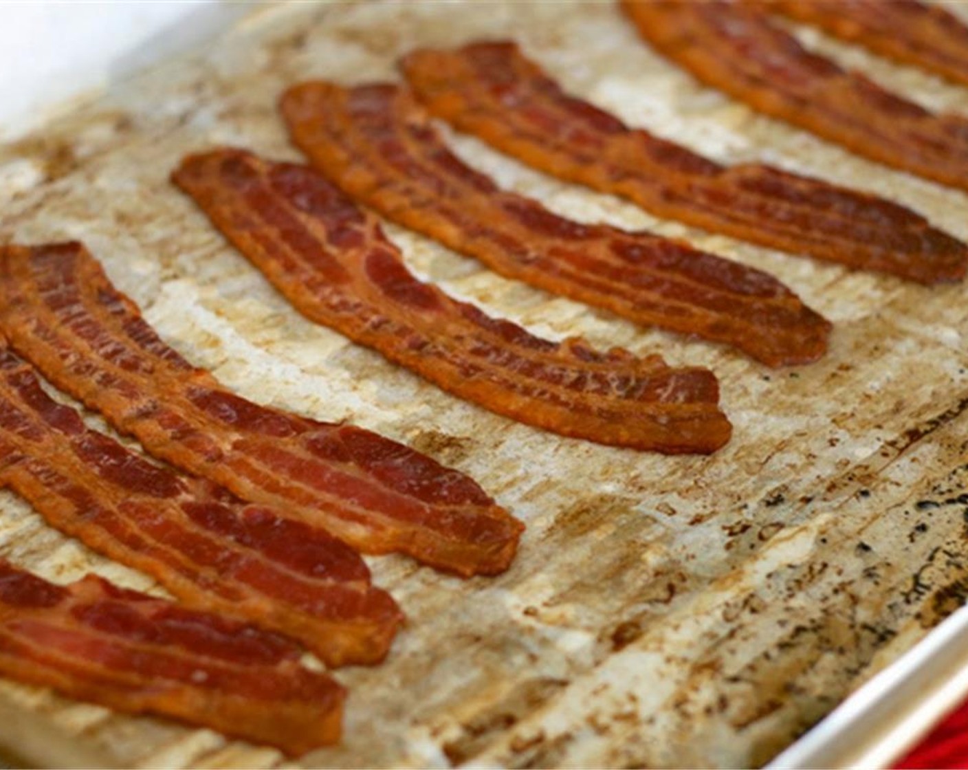 step 6 Cook bacon in a 350 degrees F (180 degrees C) oven for about 30 minutes or until bacon has rendered out all the fat and strips are crispy. Drain fat and store bacon covered at room temperature for up to 24 hours.