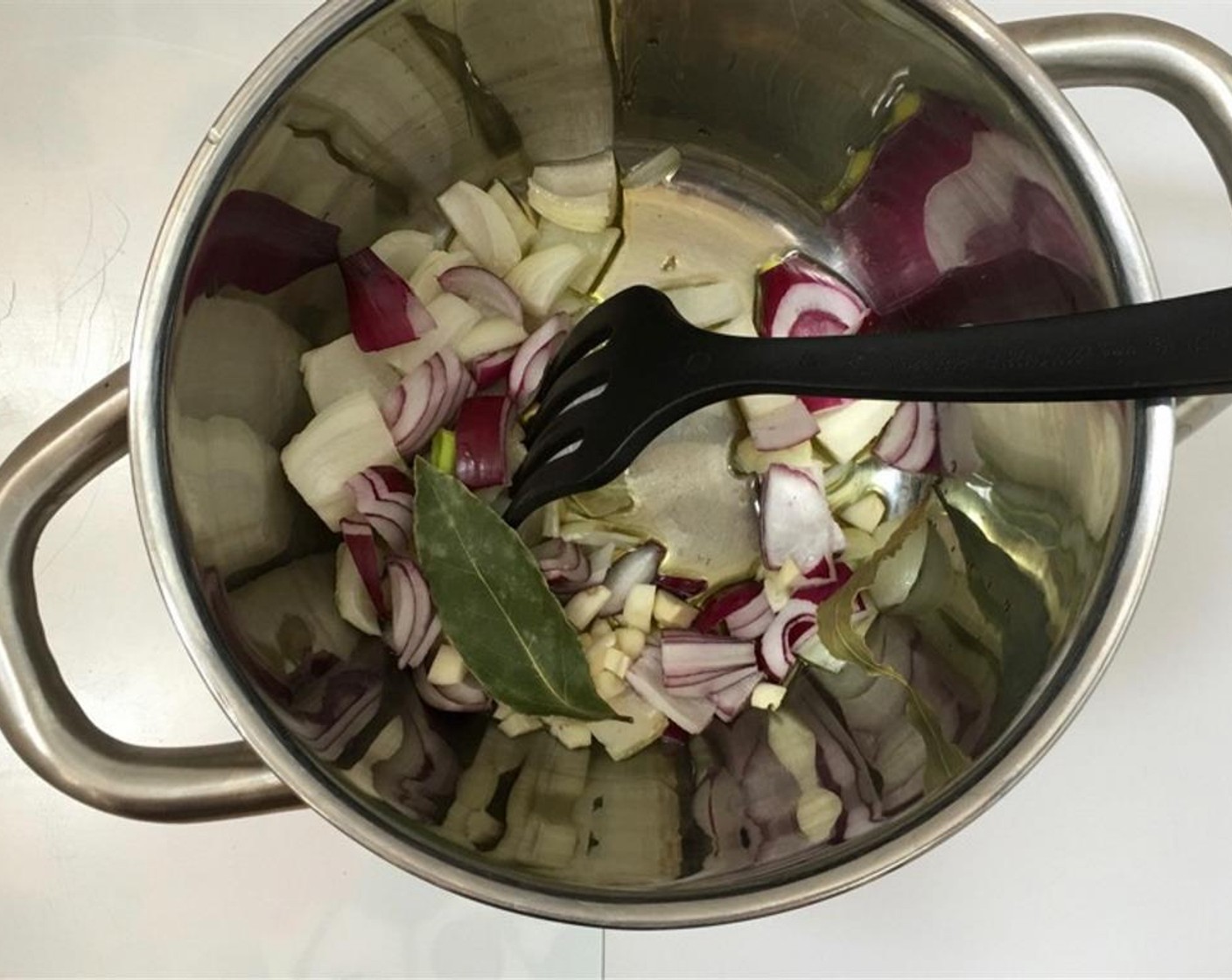 step 1 Peel and chop the Onion (1) and the Garlic (2 cloves). Add them to a large saucepan together with the Bay Leaves (2) and Olive Oil (3 Tbsp).