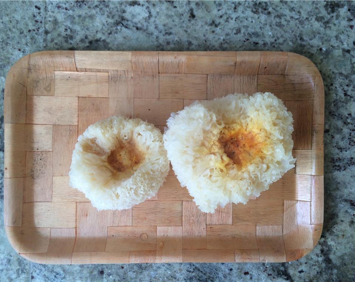 step 2 Using kitchen scissors, trim and discard the dark yellow parts on the underside of each Tremella mushroom.