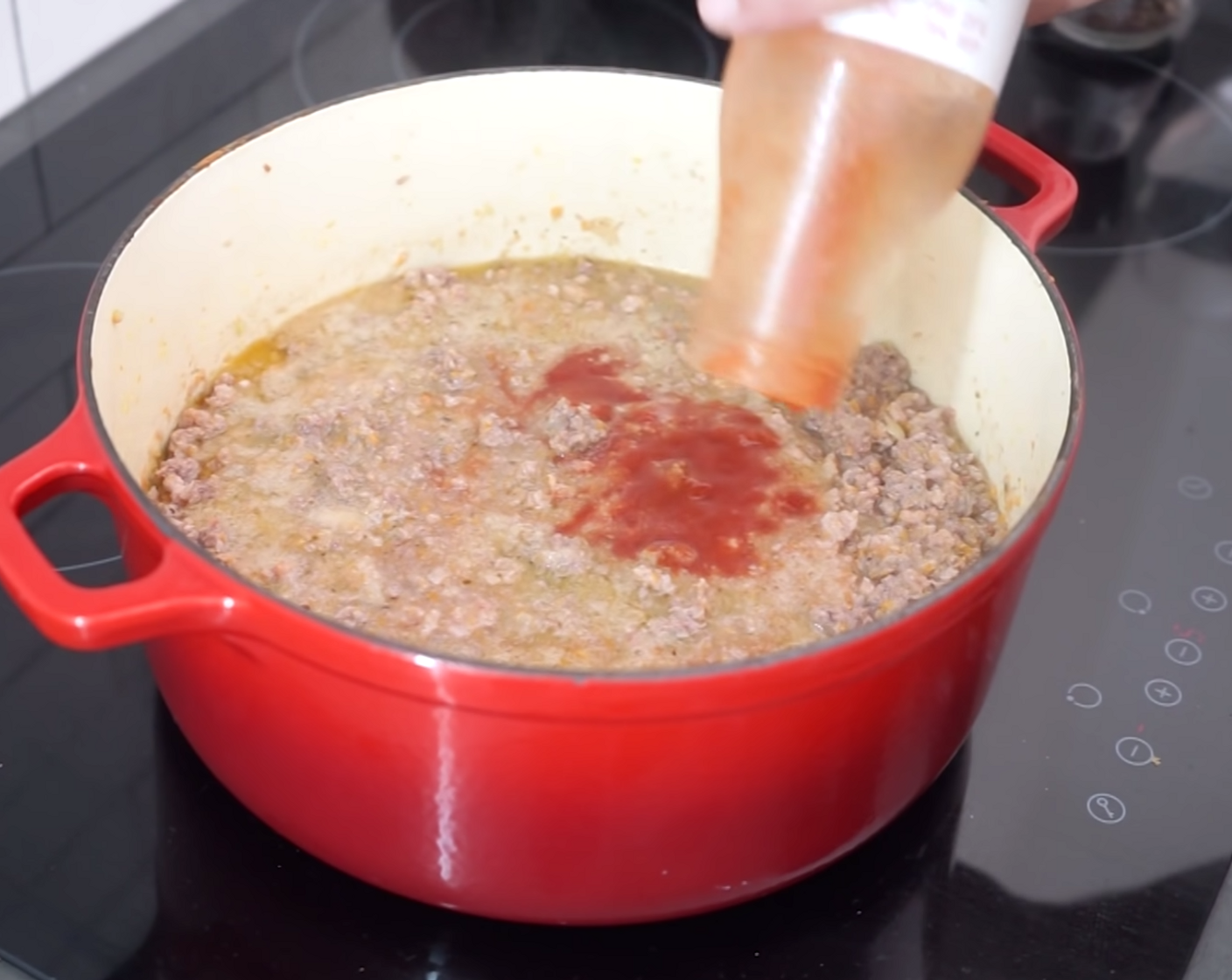 step 8 Now it’s time to add the bottle of Tomato Sauce (2 cups) and a sprinkle of Ground Black Pepper (to taste) before continuing to mix once again.