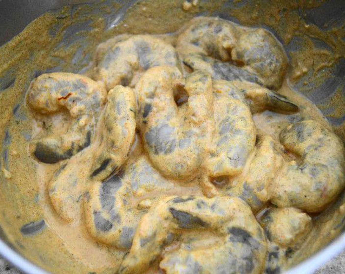 step 1 In a bowl, combine the Plain Greek Yogurt (4 Tbsp), Curry Powder (1 tsp), Garlic (1/4 tsp), juice of the Lemon (1), Sriracha (2 dashes), Smoked Paprika (1/2 tsp), Saffron Threads (1 pinch), and Shrimp (1 lb). Make sure the shrimp are well coated.