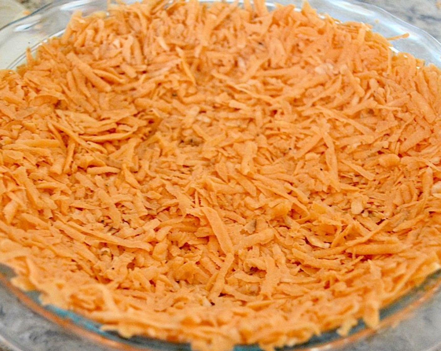 step 2 Toss the Sweet Potatoes (5) with Salt (1 pinch), Ground Black Pepper (1 pinch), and McCormick® Garlic Powder (1 pinch). Press it into the greased pan firmly, including up the sides, to form a crust.
