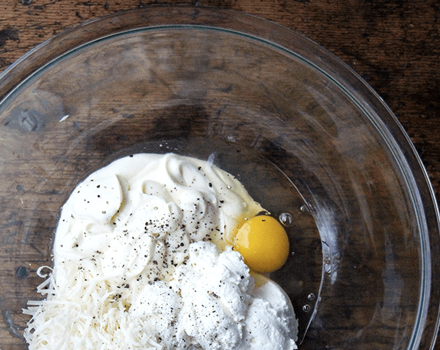 step 1 In a large bowl, combine the Ricotta Cheese (1 cup), Crème Fraîche (1 cup), Egg (1), and 1/2 cup of the Pecorino Romano Cheese (1/2 cup). Season with Kosher Salt (to taste) and Freshly Ground Black Pepper (to taste) and set aside.