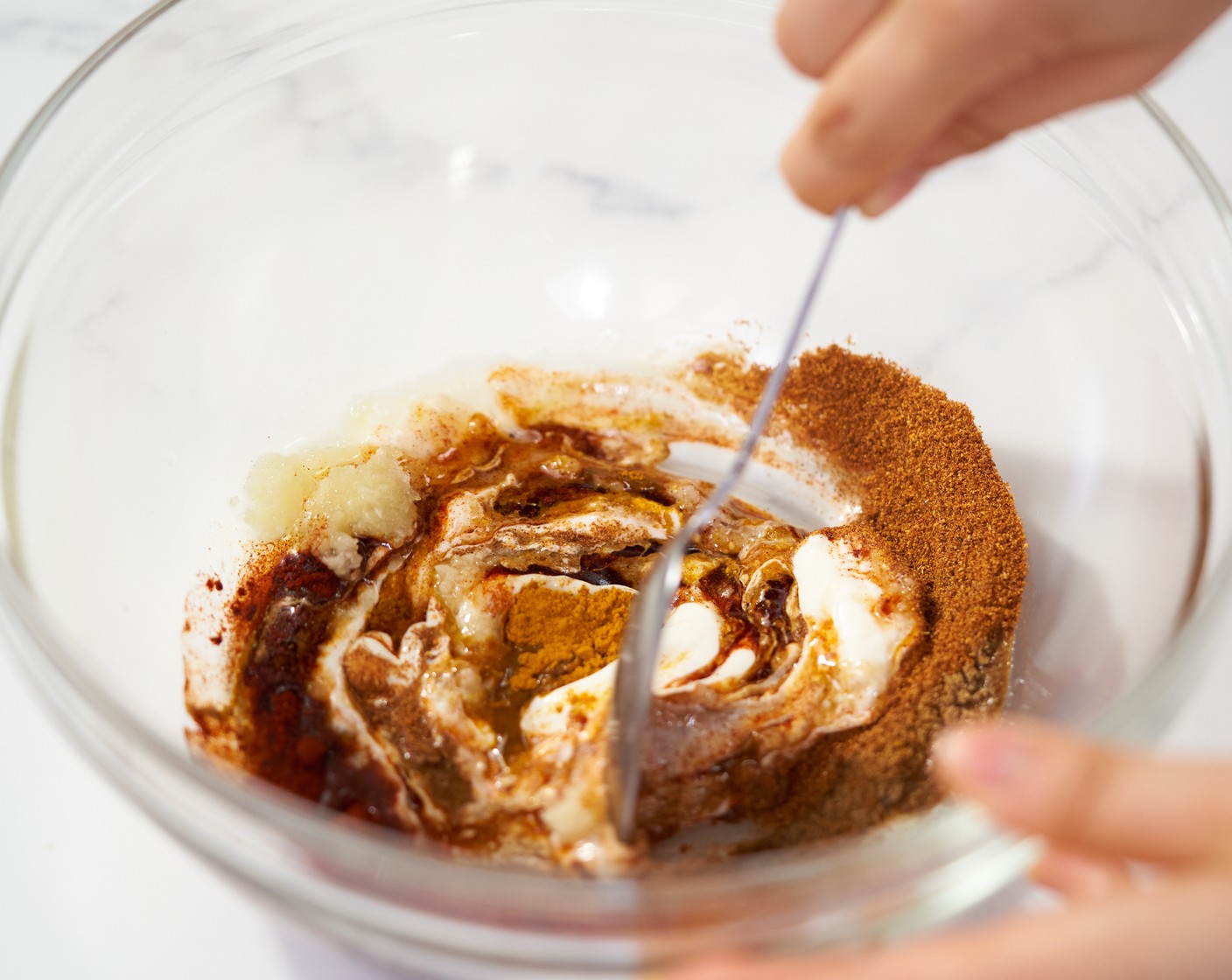 step 1 In a large mixing bowl, add Garlic (4 cloves), Olive Oil (2 Tbsp), Greek Yogurt (2 Tbsp), 2 Tbsp of Lemon Juice (1), Paprika (2 tsp), Salt (1 tsp), Ground Coriander (1 tsp), Ground Cumin (1 tsp), Cayenne Pepper (1 tsp), and Ground Turmeric (1/2 tsp). Mix well.