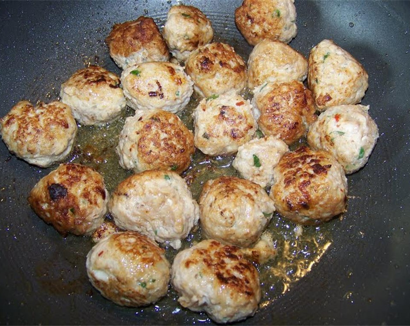 step 5 Once meatballs are browned, transfer to a plate and set aside until they are finished off in the sauce. Reserve the oil from frying the meatballs in the pan to make the sauce.