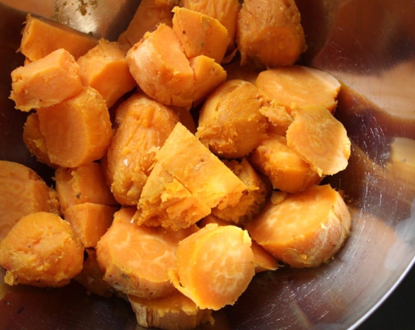 step 7 Peel the potatoes and place the flesh in a large mixing bowl, discarding the skin. With a hand mixer on low speed or a potato masher, beat the potato mixture until smooth.