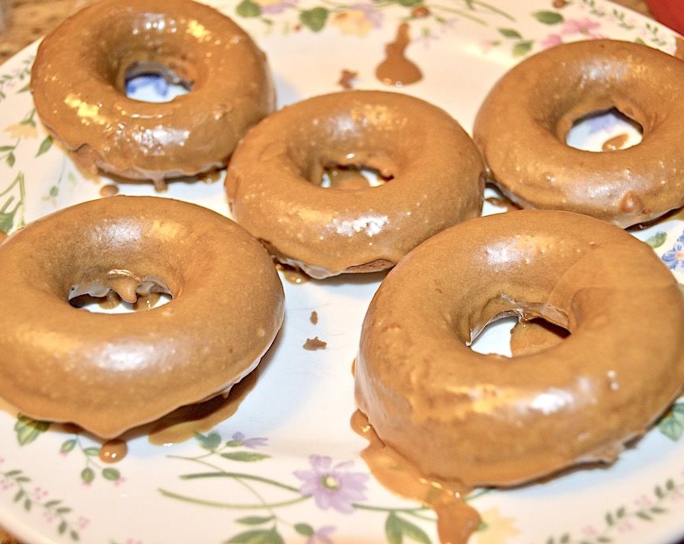 step 11 Submerge the top half of each donut in the glaze and transfer them to a plate to harden.