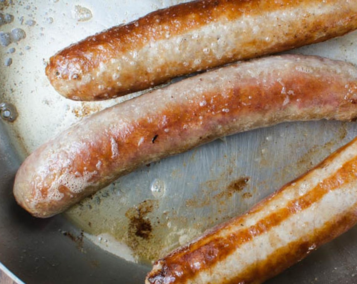 step 1 In a 10-inch skillet with a tight-fitting lid, heat the Olive Oil (2 Tbsp) over medium-high heat. When the oil starts to glisten and shimmer, carefully add the Irish Banger Sausage (1 lb) and cook, turning occasionally until browned.