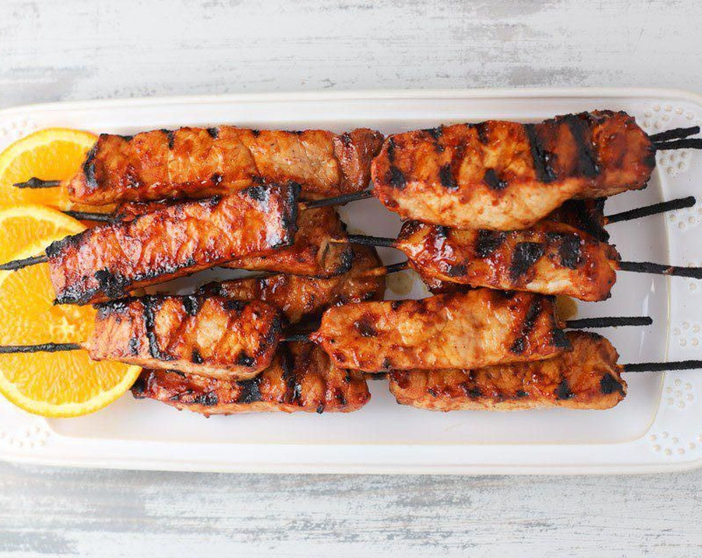 step 4 Place skewers on the grill and discard marinate. Grill on both sides until done throughout (about 5 minutes a side). Maintain at least a 350 degrees F (180 degrees C) temperature for good sear marks.