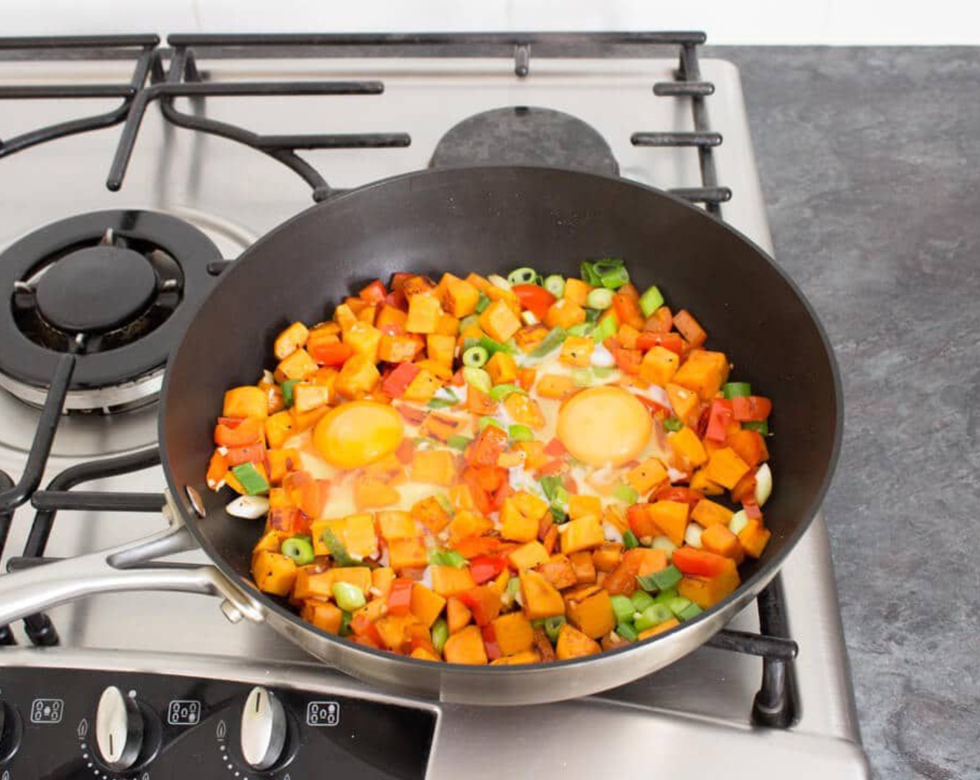 step 3 Give it another stir then make 2 wells and crack an Eggland's Best Classic White Eggs (2) into each one. Reduce the heat to low. Pop the lid back on and cook for 3 – 4 minutes until the egg whites are cooked but the yolks are still runny.