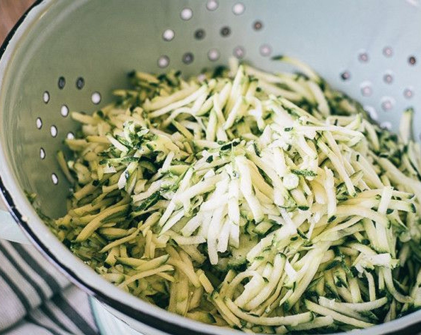 step 2 While oven heats, add Zucchini (3 cups) in food processor then put in a strainer, add Salt (1/4 tsp) and let sit for 10 minutes.