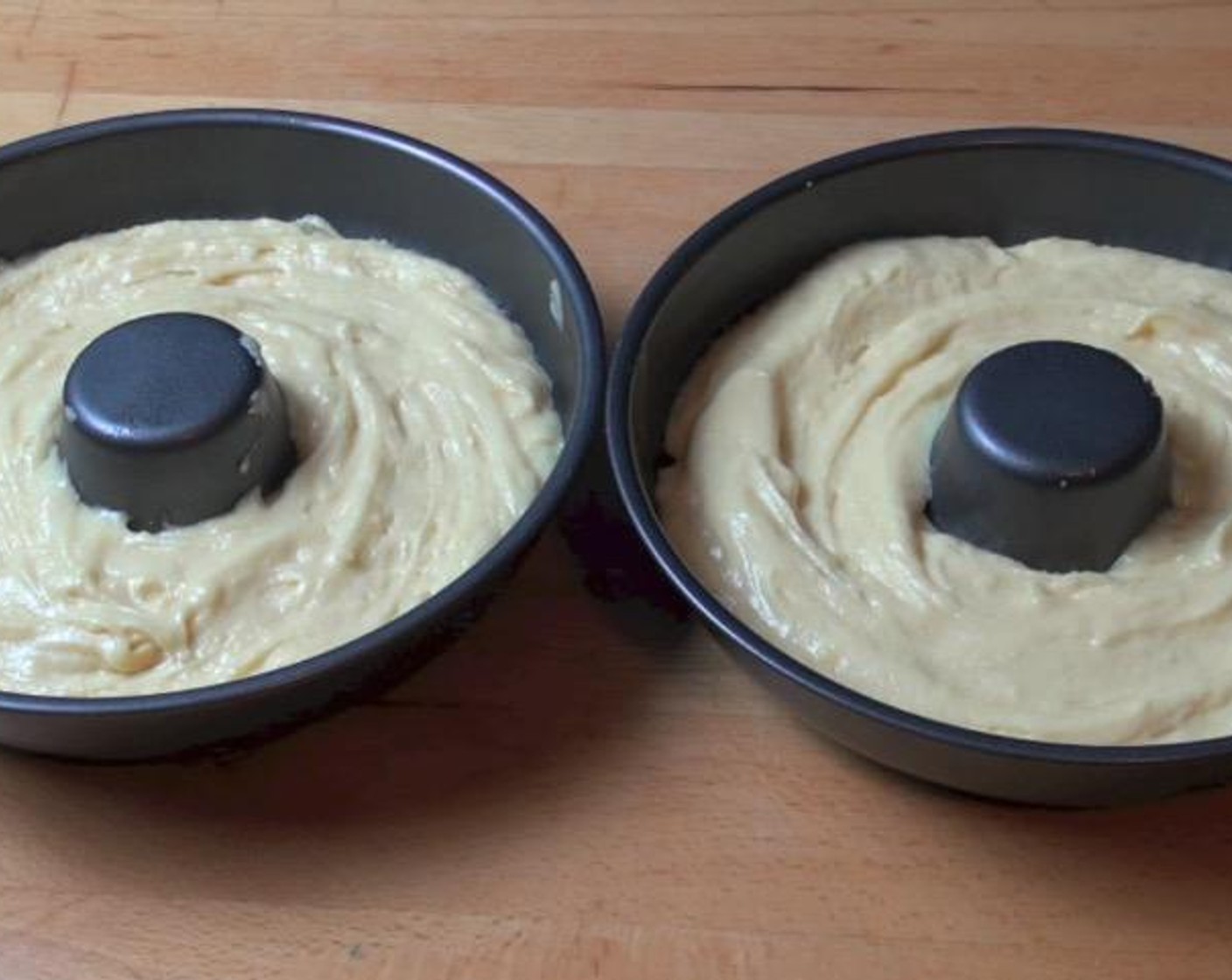 step 4 Divide the batter into two large donut cake tins, lightly greased.