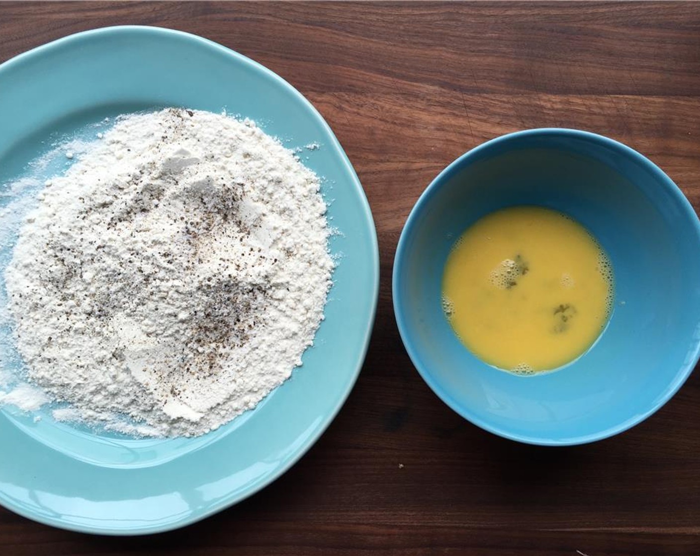 step 4 Place the All-Purpose Flour (1 cup) on a plate, and stir in the Salt (1/2 tsp) and Freshly Ground Black Pepper (1/4 tsp). Place the Egg (1) in a bowl.