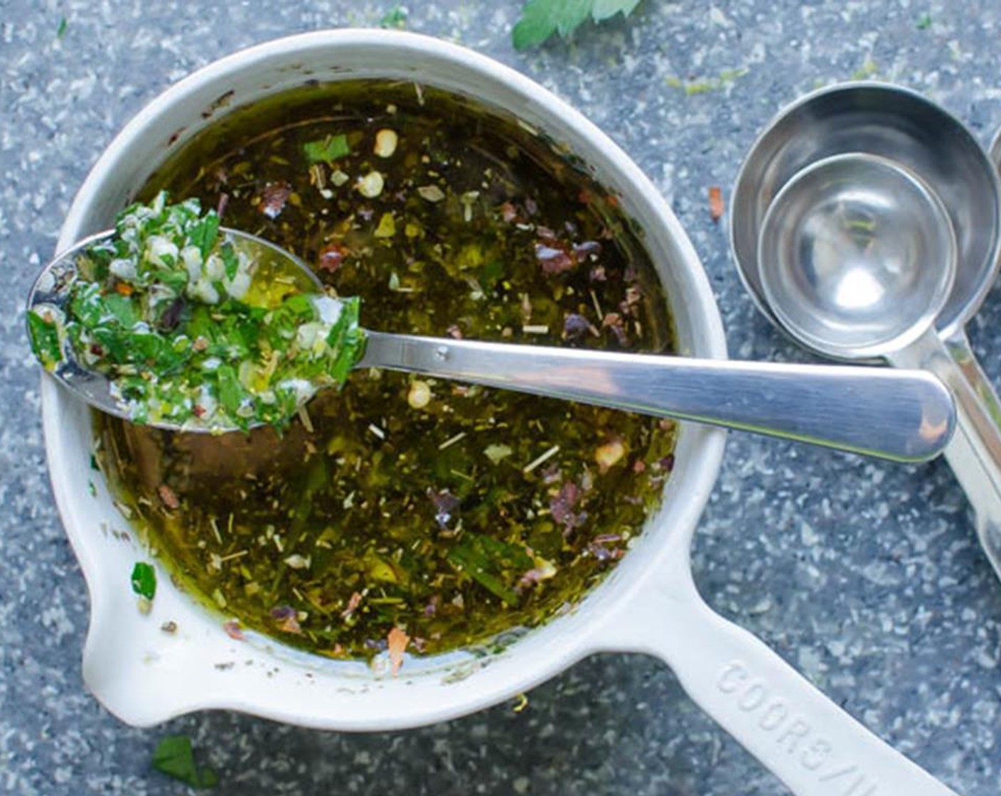 step 4 Add the Fresh Parsley (4 Tbsp), Garlic (1 clove), Kosher Salt (1/2 tsp), Ground Black Pepper (1/4 tsp), Dried Oregano (1/2 tsp) and Crushed Red Pepper Flakes (1 pinch).