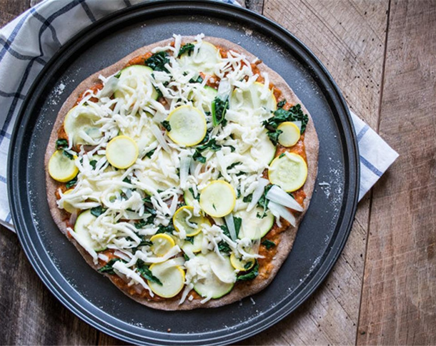 step 8 Remove from the oven, add homemade sauce, chopped Kale (10 g), sliced Onions (75 g), zucchini, squash, and Shredded Mozzarella Cheese (45 g), then top with the Eggs (3). Bake an additional 5 minutes.