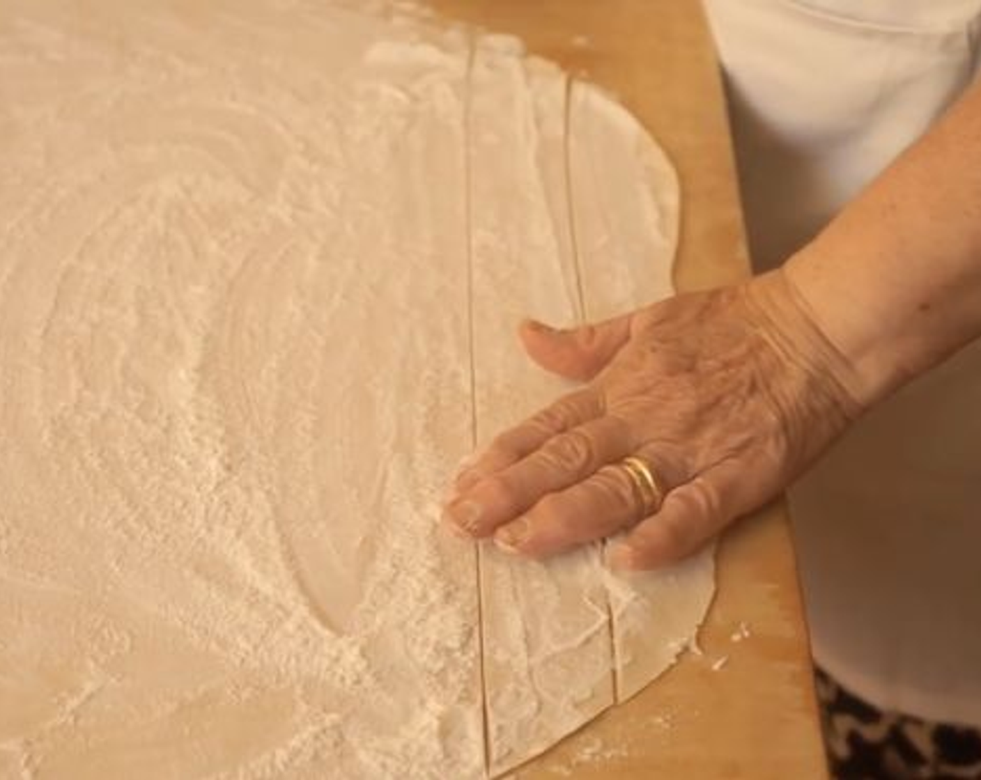 step 7 Once the dough has rested, begin flattening it using your hands for a couple of minutes. Then, with the rolling pin, start to roll out the dough, moving it forward and back, by pressing gently and spreading the dough from the center, out. Continue this process until the dough reaches the desired thickness.