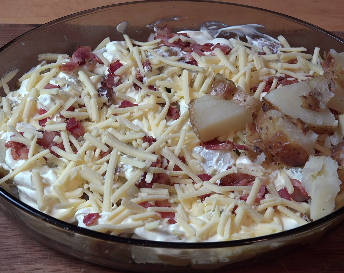 step 10 Sprinkle over half of the bacon and Cheddar Cheese (2 cups). Top of with the remaining potatoes.