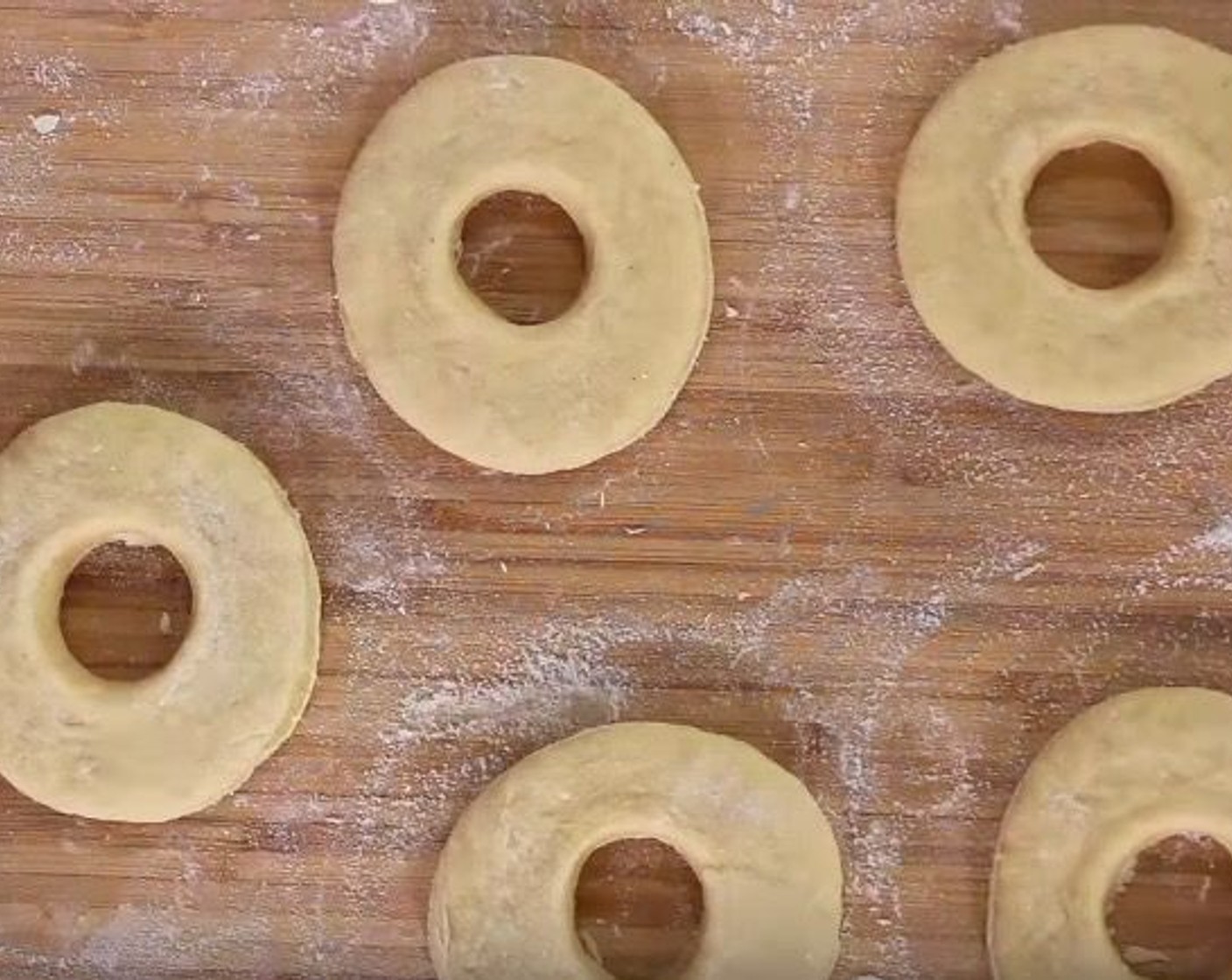 step 6 Divide the dough into 4 separate pieces. Roll each piece out. Using a cookie cutter the size of a donut, cut out donuts. Using an apple corer, press in the middle to cut out the donut hole.