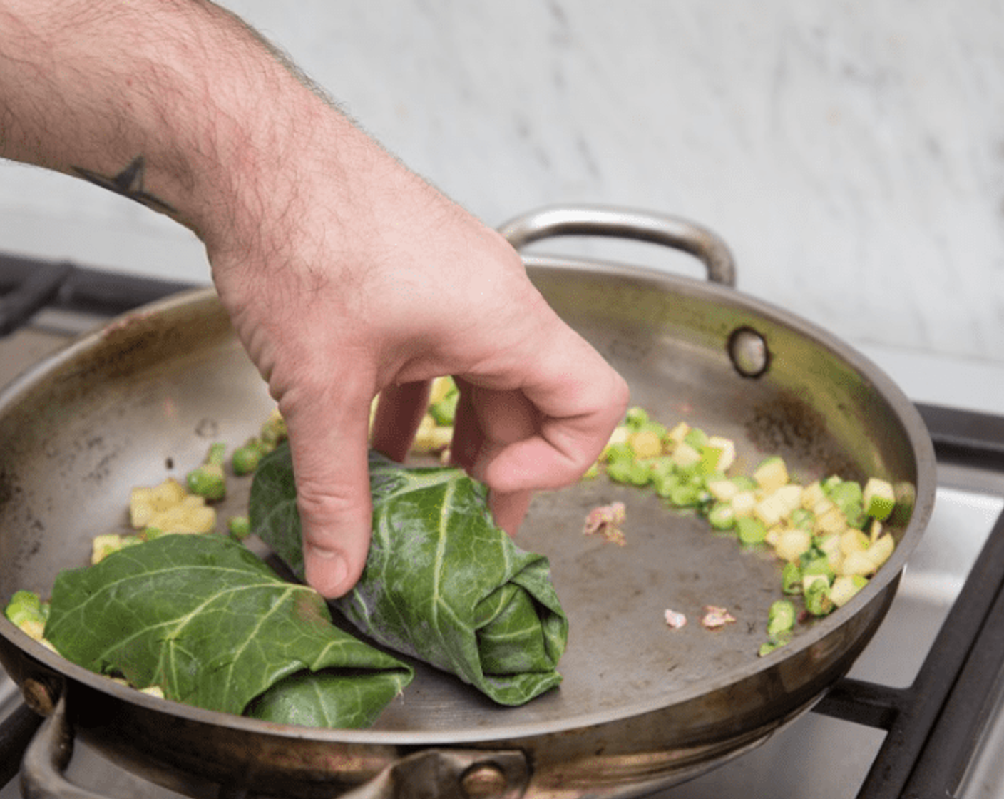 step 11 Place stuffed collards in the pan, add Apple Cider Vinegar (to taste), Liquid Aminos (to taste) and Water (1 cup), and bring to a boil. Reduce heat to low, cover and simmer 15 minutes.