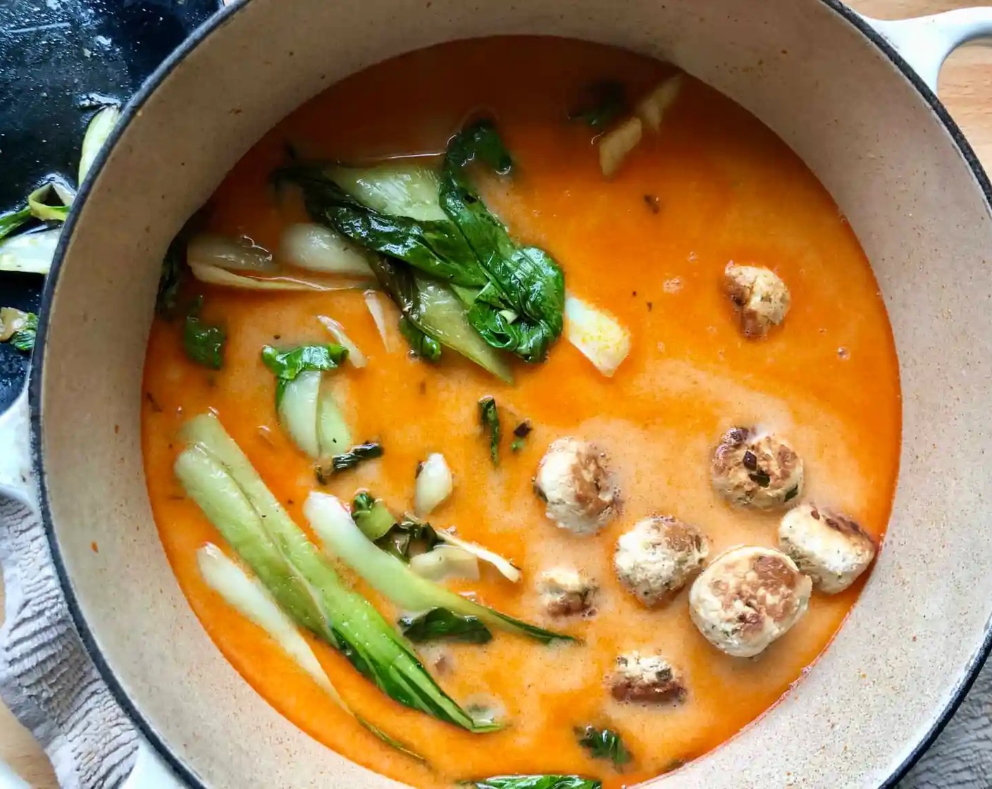 step 6 Stir in Full-Fat Coconut Milk (2 cans), Chicken Stock (3 cups), Fish Sauce (3 Tbsp), and Honey (1 Tbsp). Slide the meatballs and bok choy back into the pot with the broth. Simmer over medium heat until the meatballs are cooked through, for about 6-8 minutes.